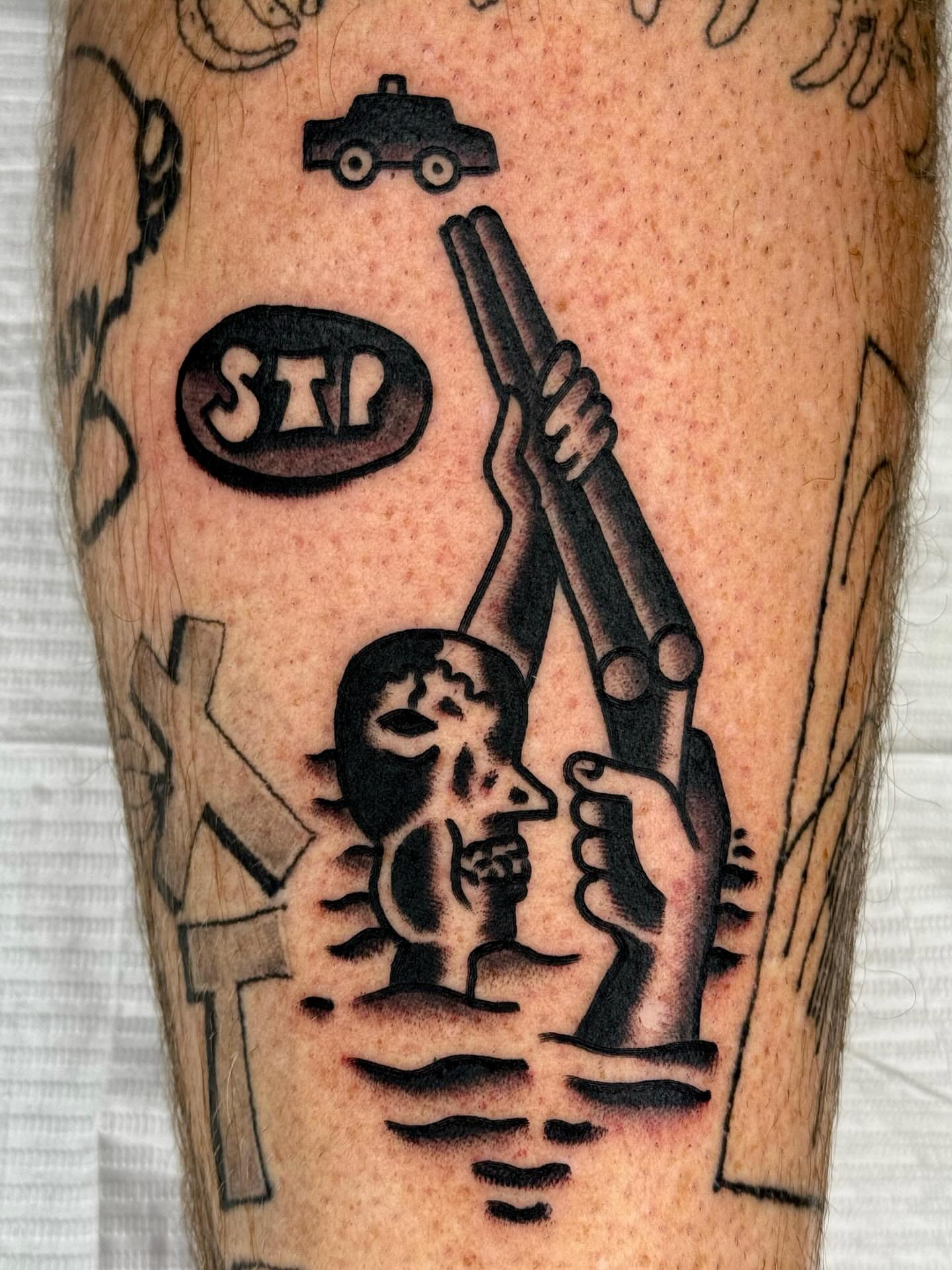 Gun and skull black and grey tattoo on the forearm by JAX