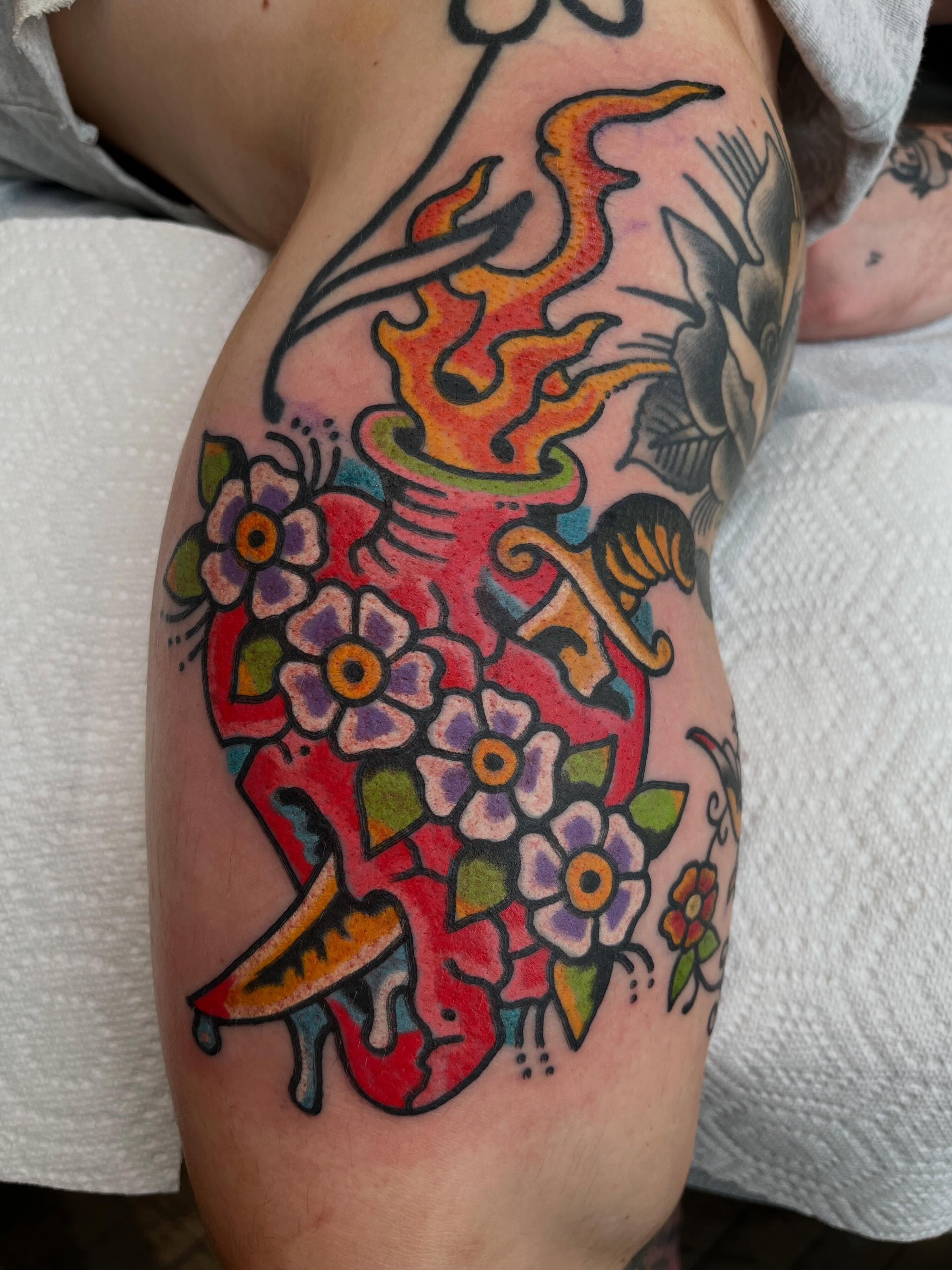 Floral vase American traditional tattoo on the thigh by Chris Kline