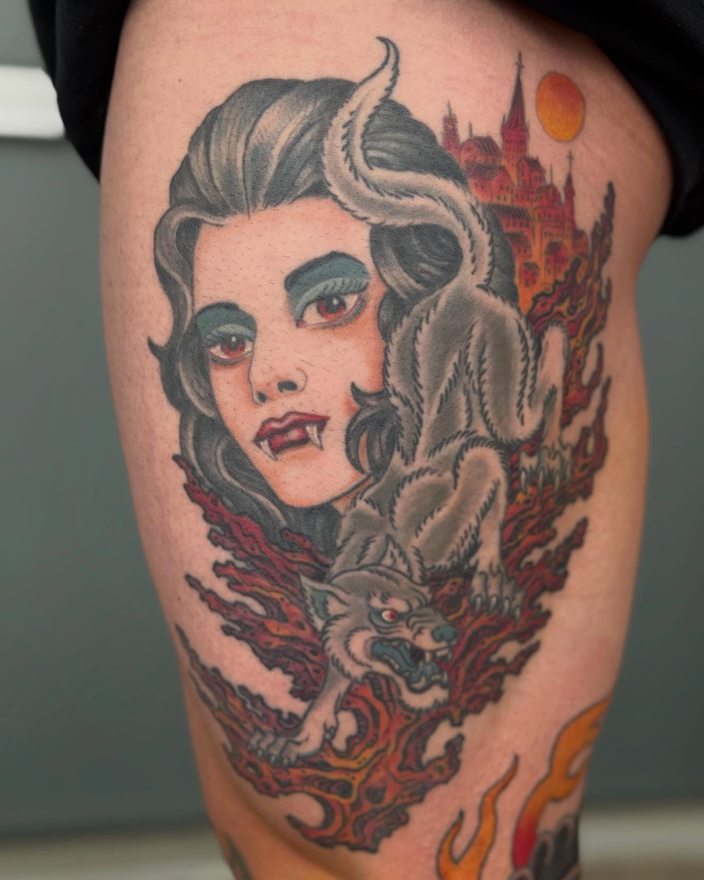 Woman with wolf American traditional tattoo on the thigh by Jesse Gray
