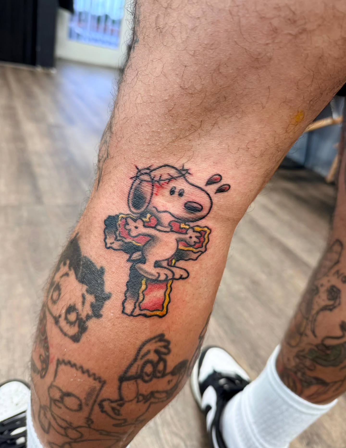 Snoopy American traditional tattoo on the forearm by Chris