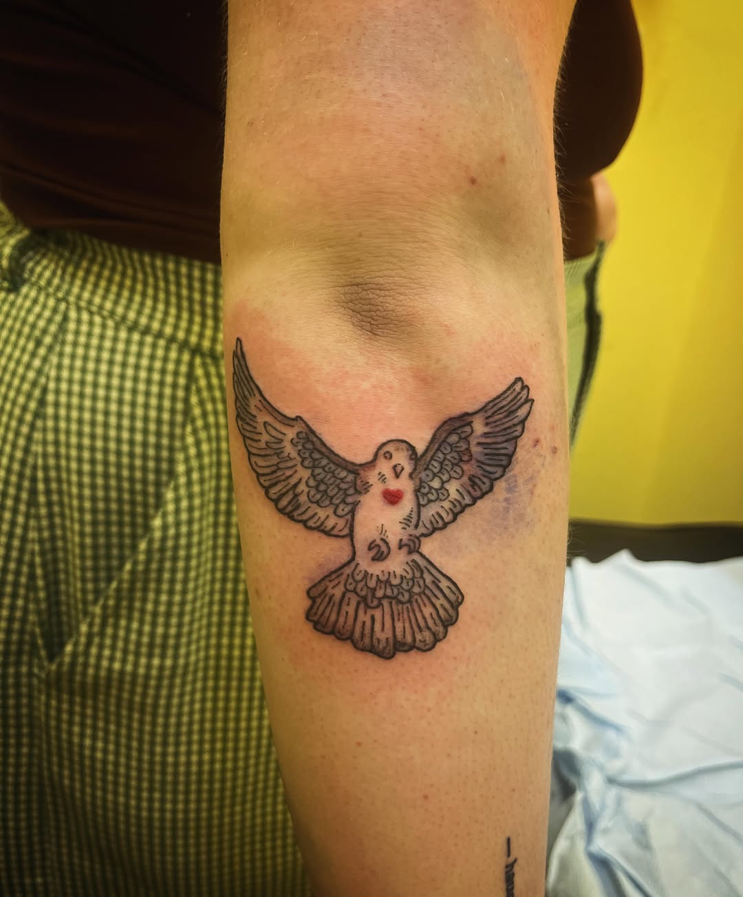 Owl black and grey tattoo on the forearm by Rafaela Lopez
