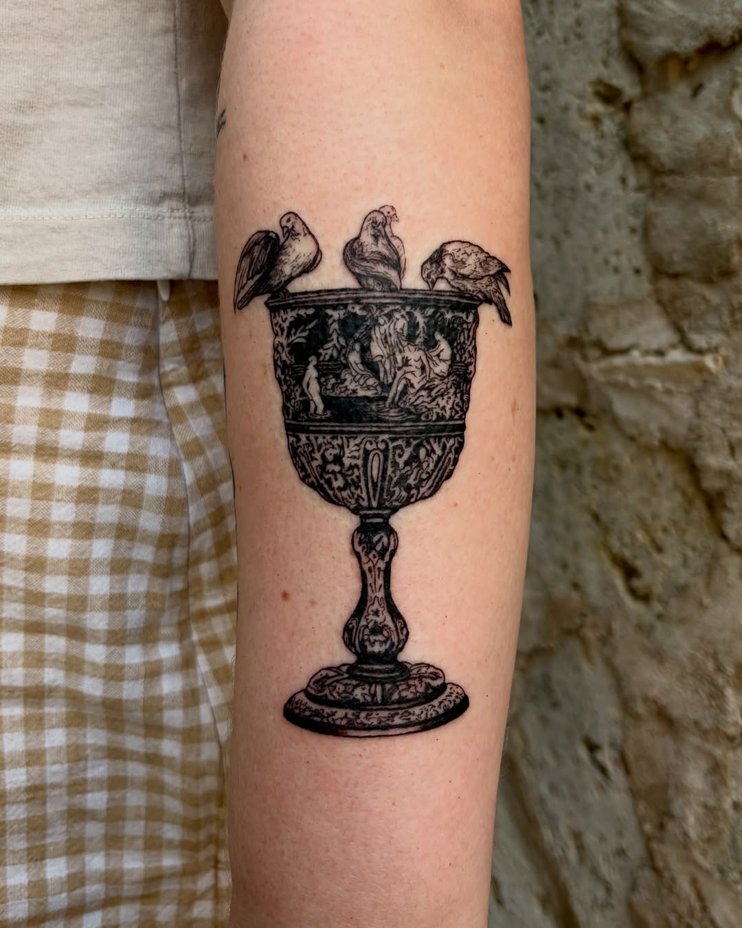 Ornate goblet with birds ornamental tattoo on the forearm by Kylah Amin Tattoo