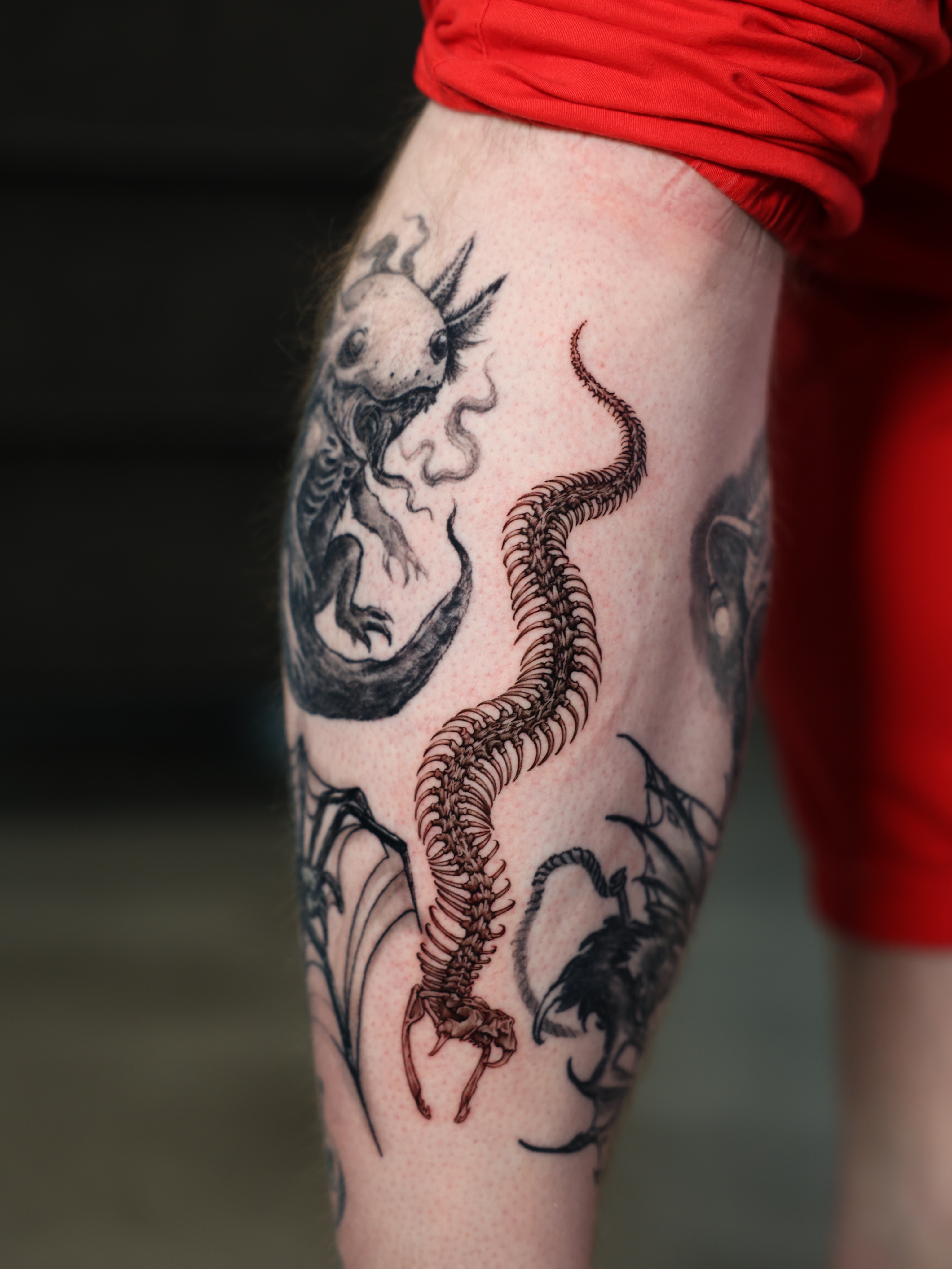 Spine and creature dark realism tattoo on the forearm by Tiny