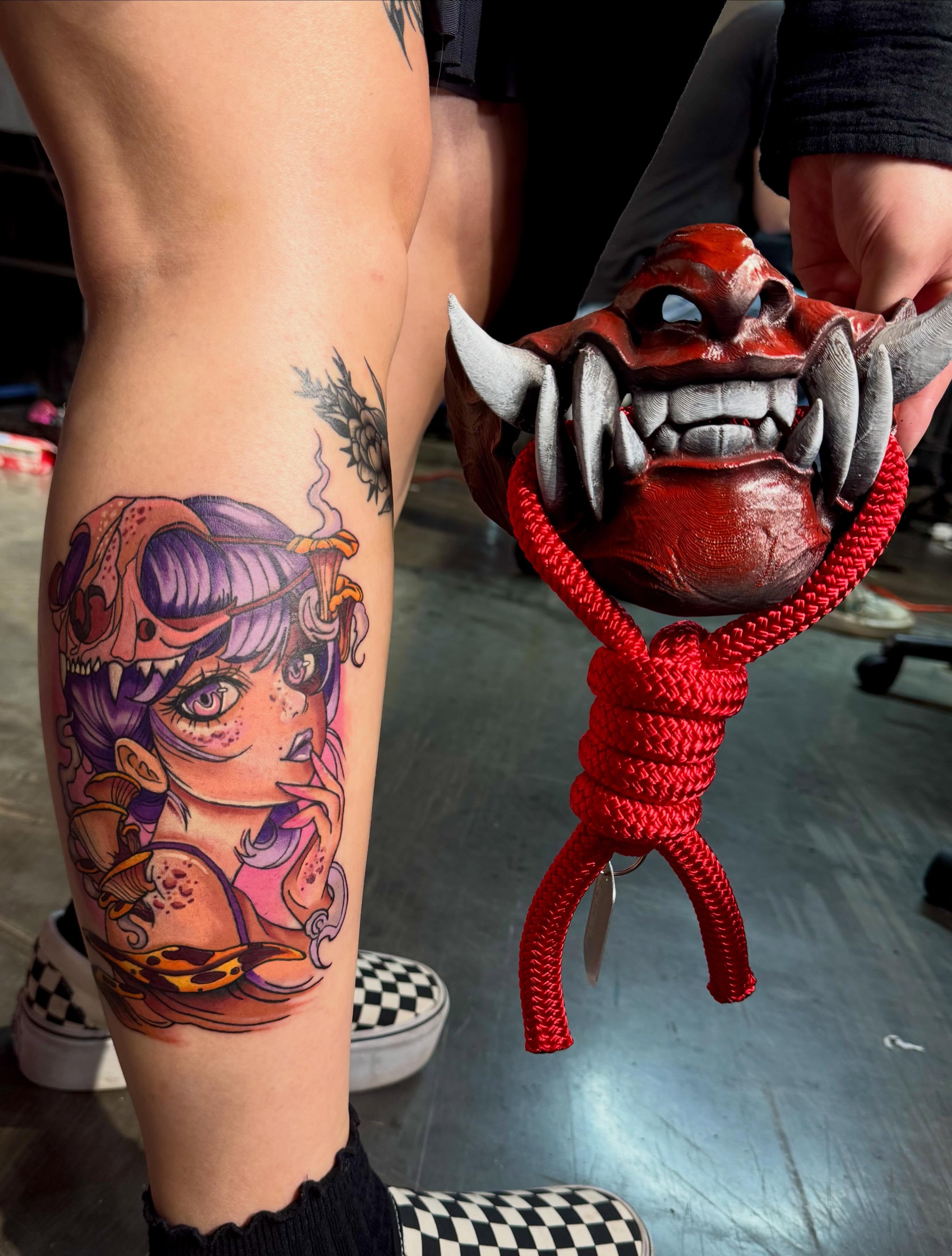 Woman with skull anime tattoo on the thigh by Kalina Lynn