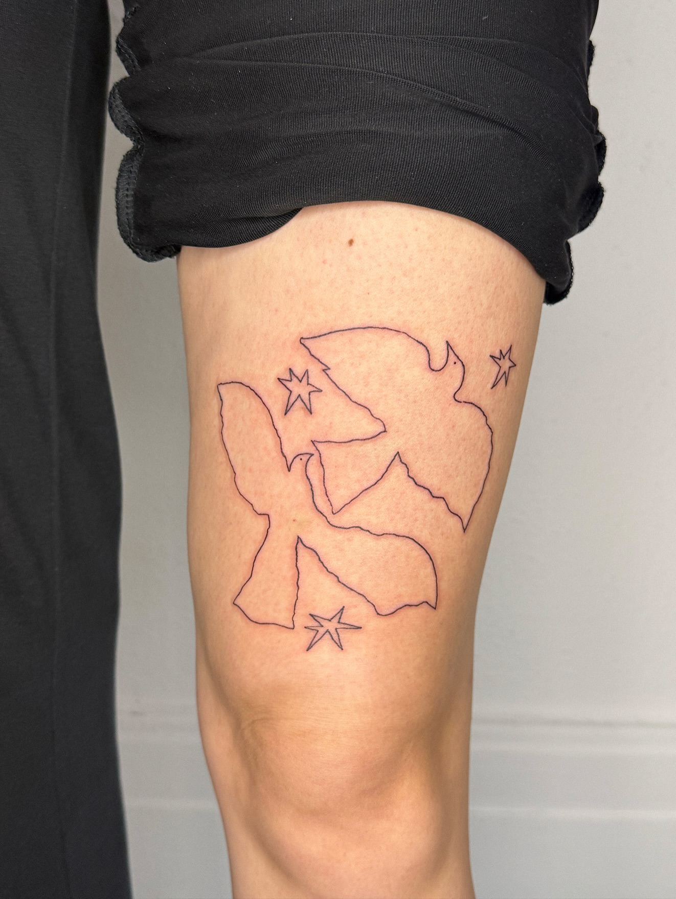 Angel fine line tattoo on the thigh by Eden Kalif