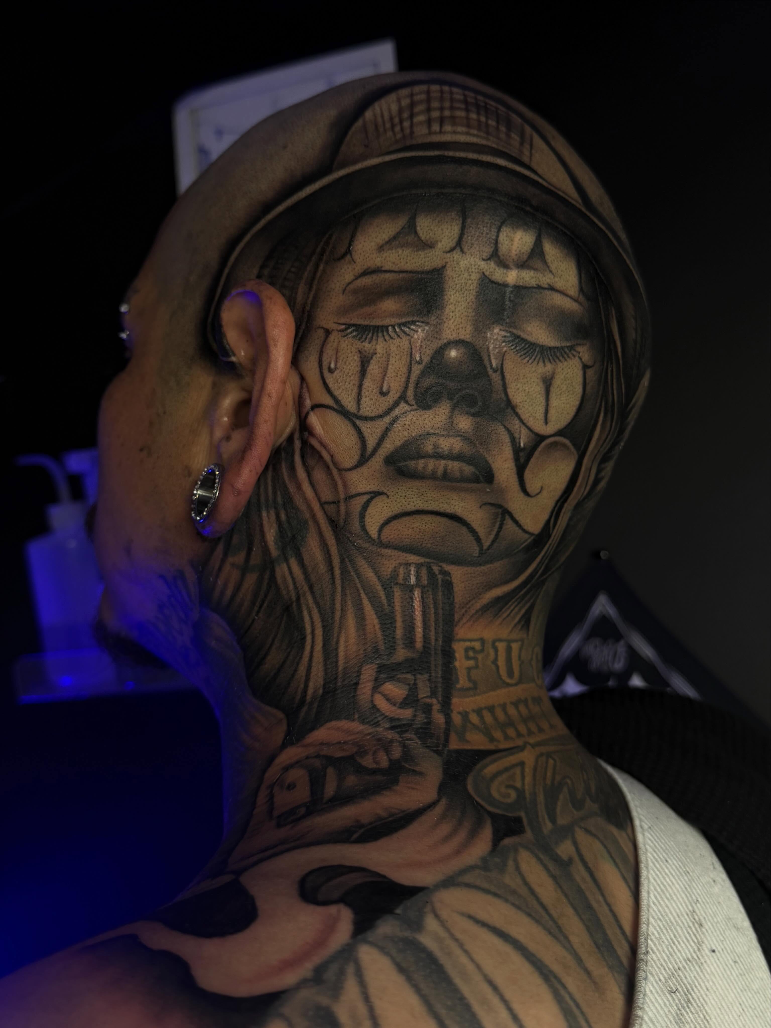 Face with cross black and grey tattoo on the neck by San Diego Tattoo Artist