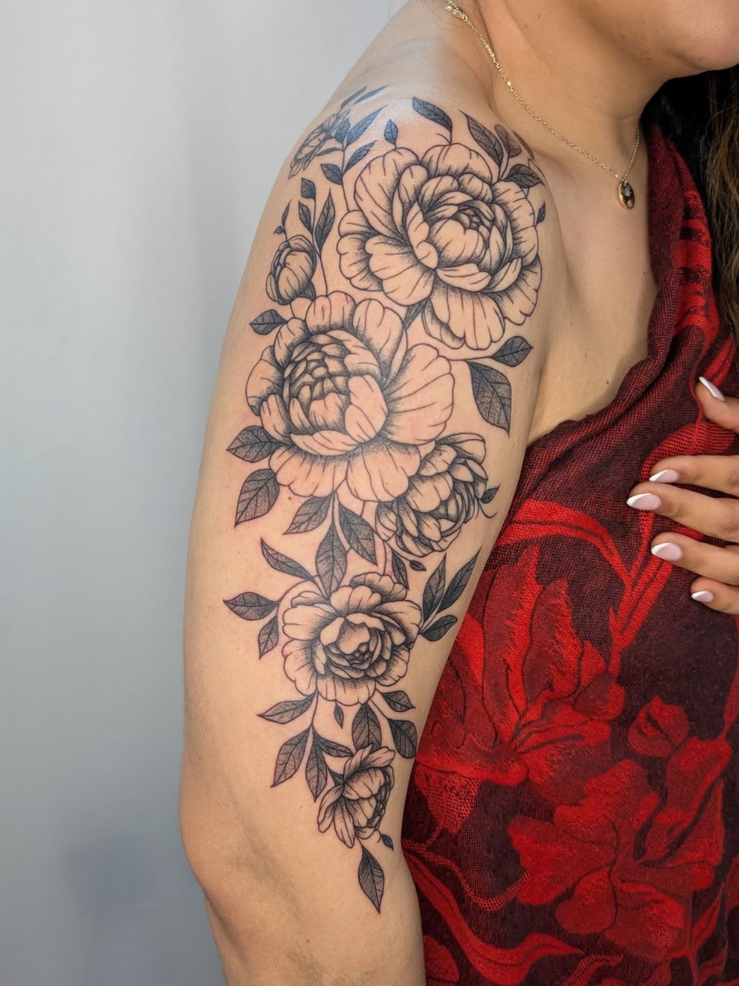 Peonies and leaves dotwork tattoo on the shoulder by Nenookaasi Martin