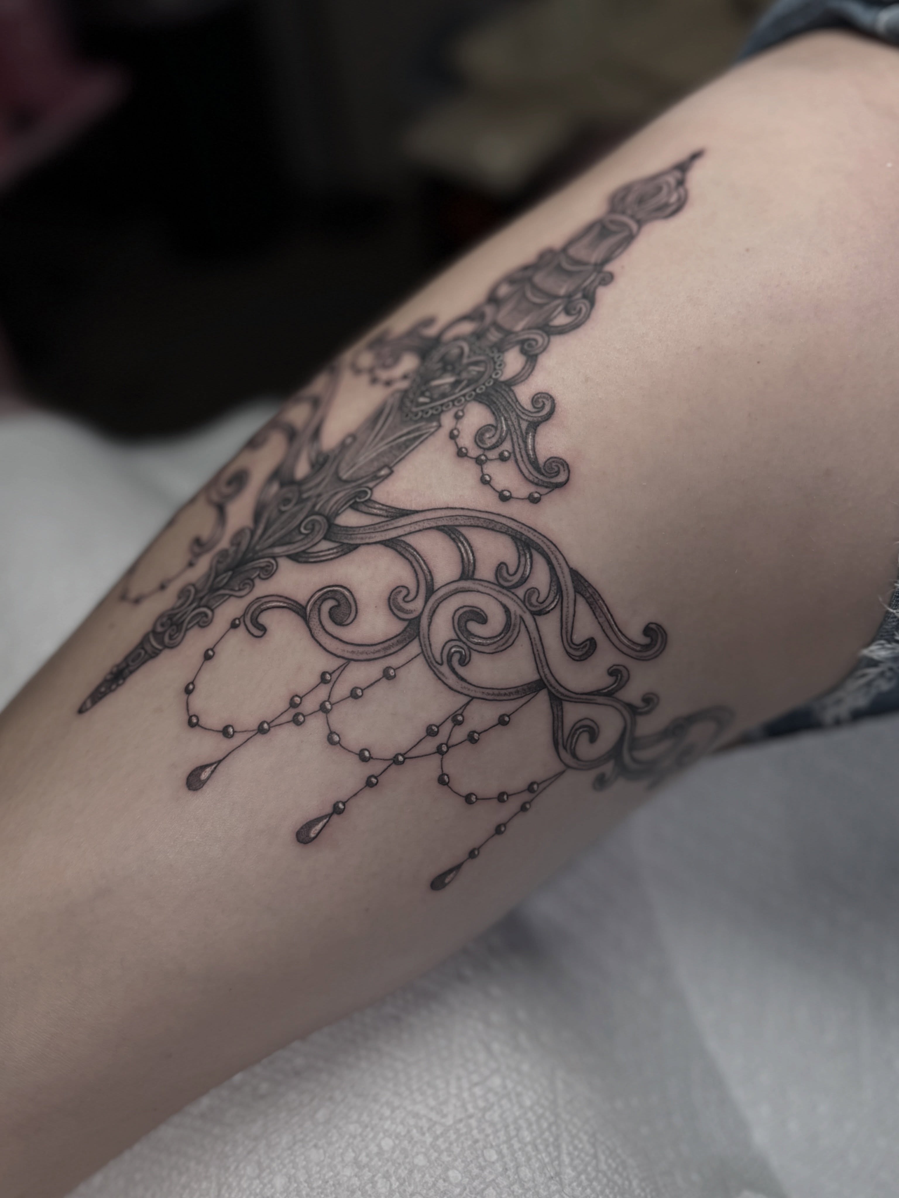 Sword and floral ornamental tattoo on the forearm by Mara Flores βπΛβ§