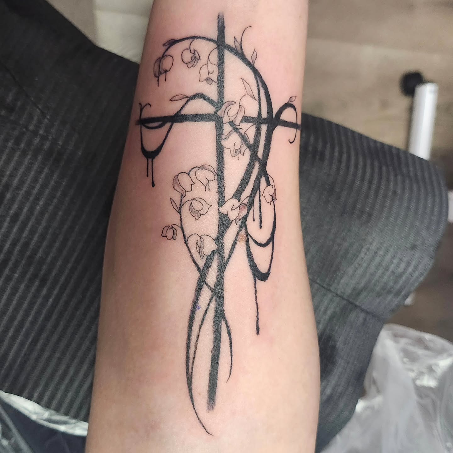 Cross with lilies black and grey tattoo on the forearm by Meredith 🎈 Tattoo the Bride ✝️