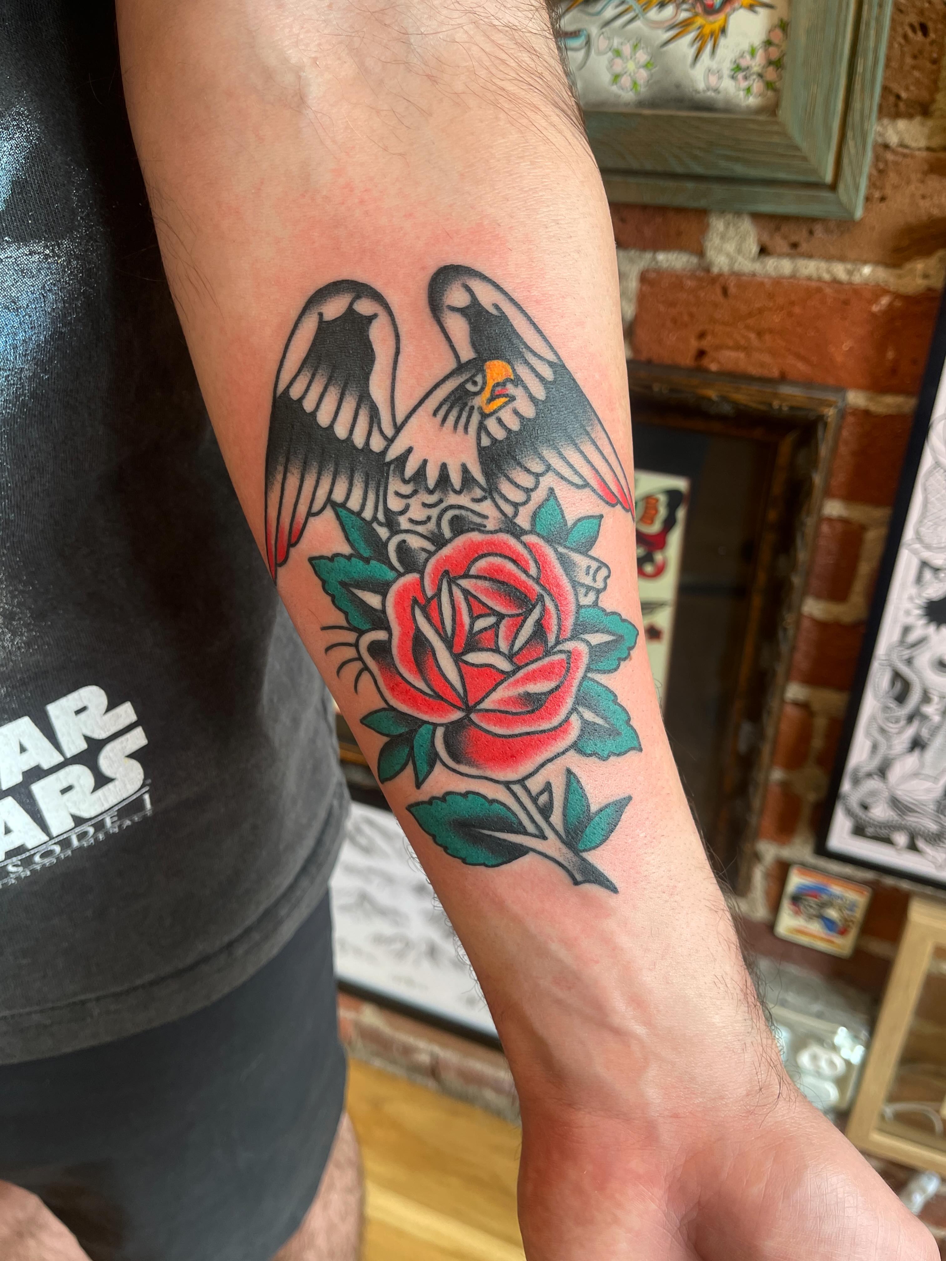 Eagle and rose American traditional tattoo on the forearm by Spencer Reisbeck