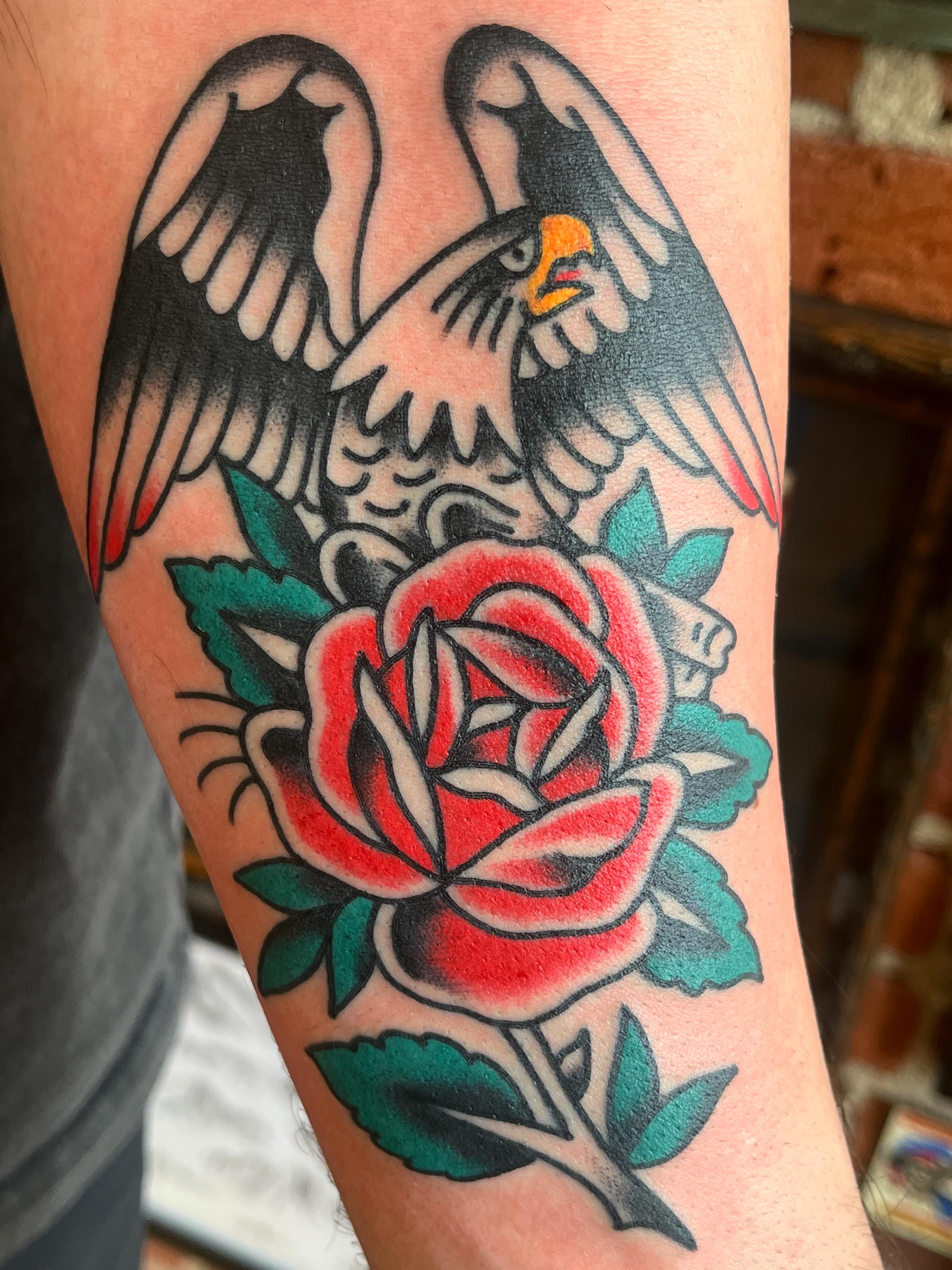 Eagle and rose American traditional tattoo on the forearm by Spencer Reisbeck