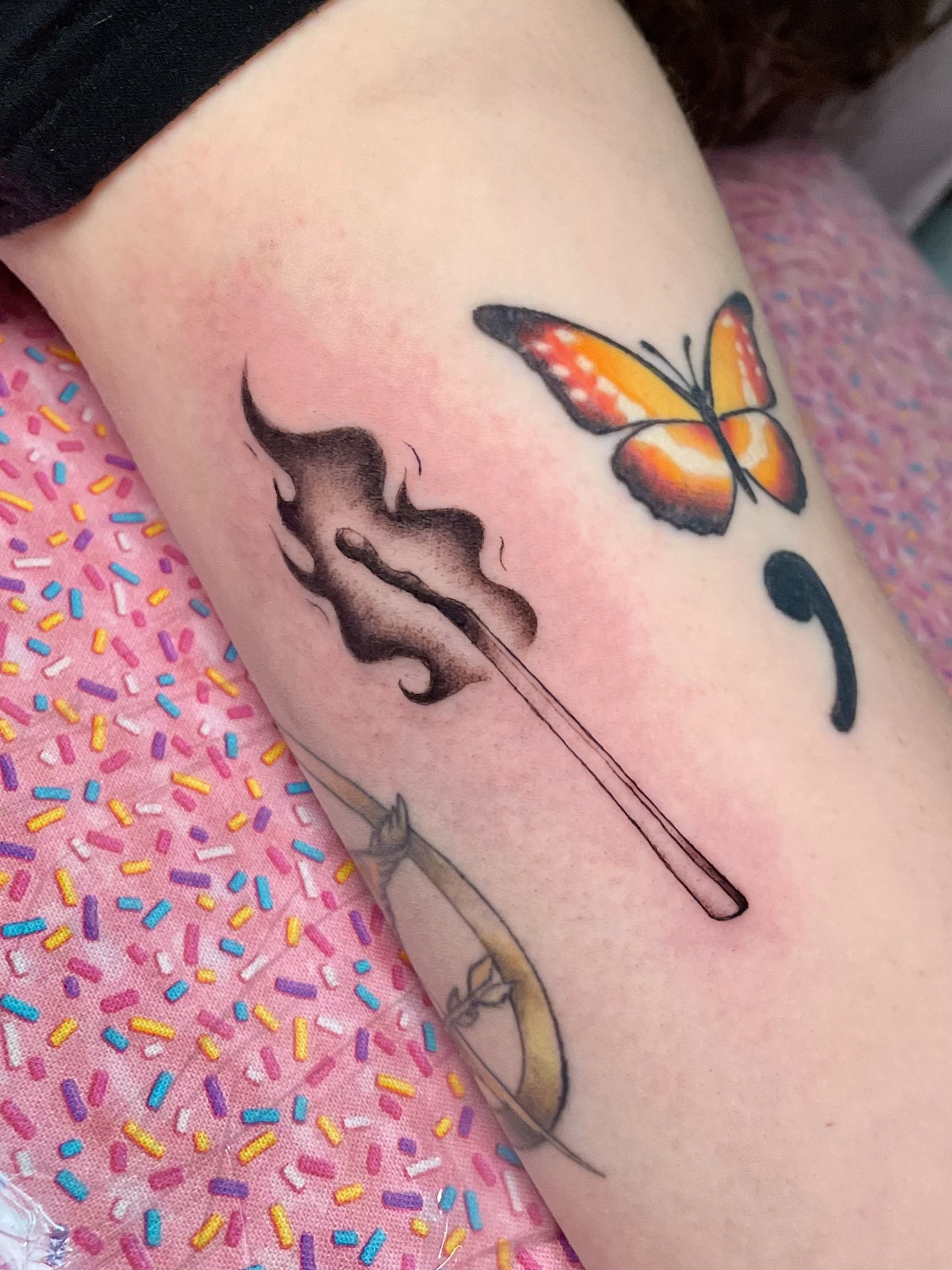 Marshmallow and butterfly realism tattoo on the forearm by Liv
