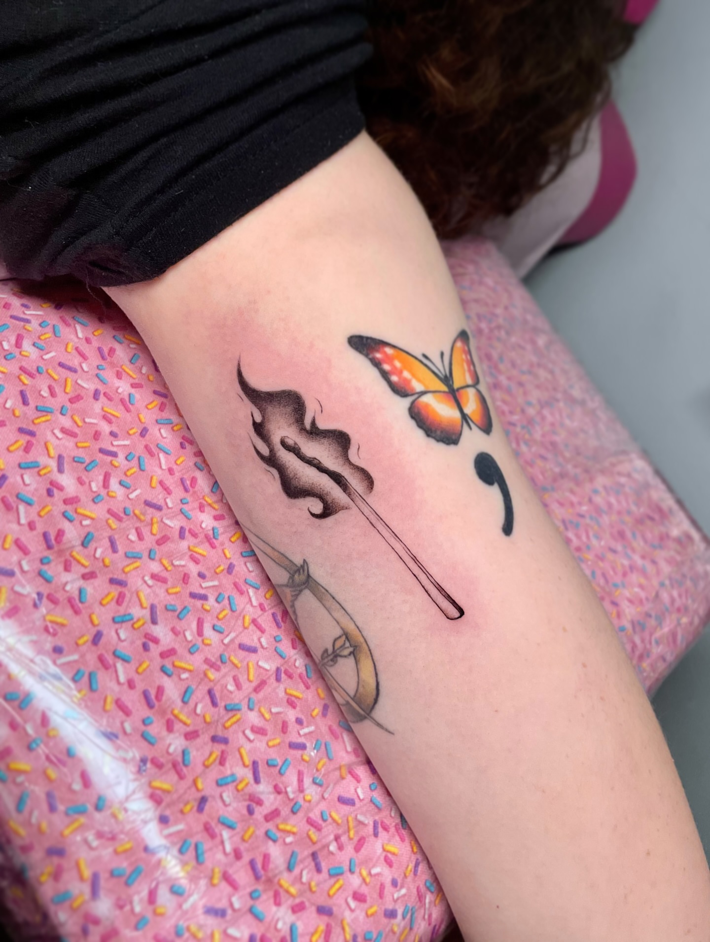 Butterfly and feather realism tattoo on the forearm by Liv