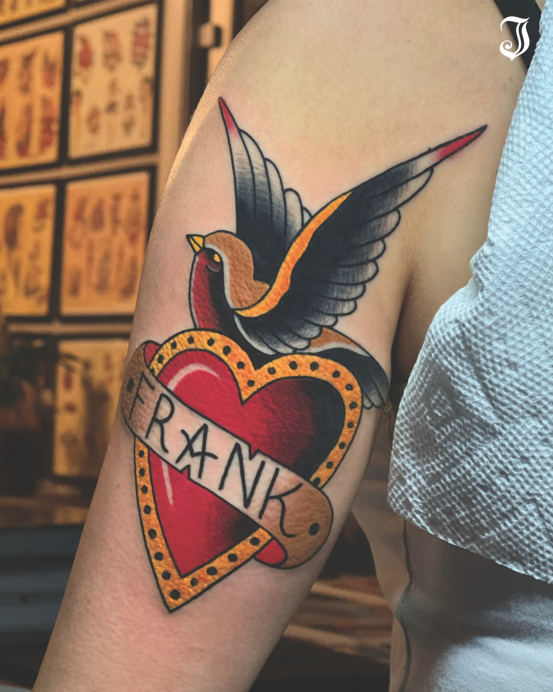 Bird and heart American traditional tattoo on the forearm by Ryan Moraski, Colorado Springs, Colorado
