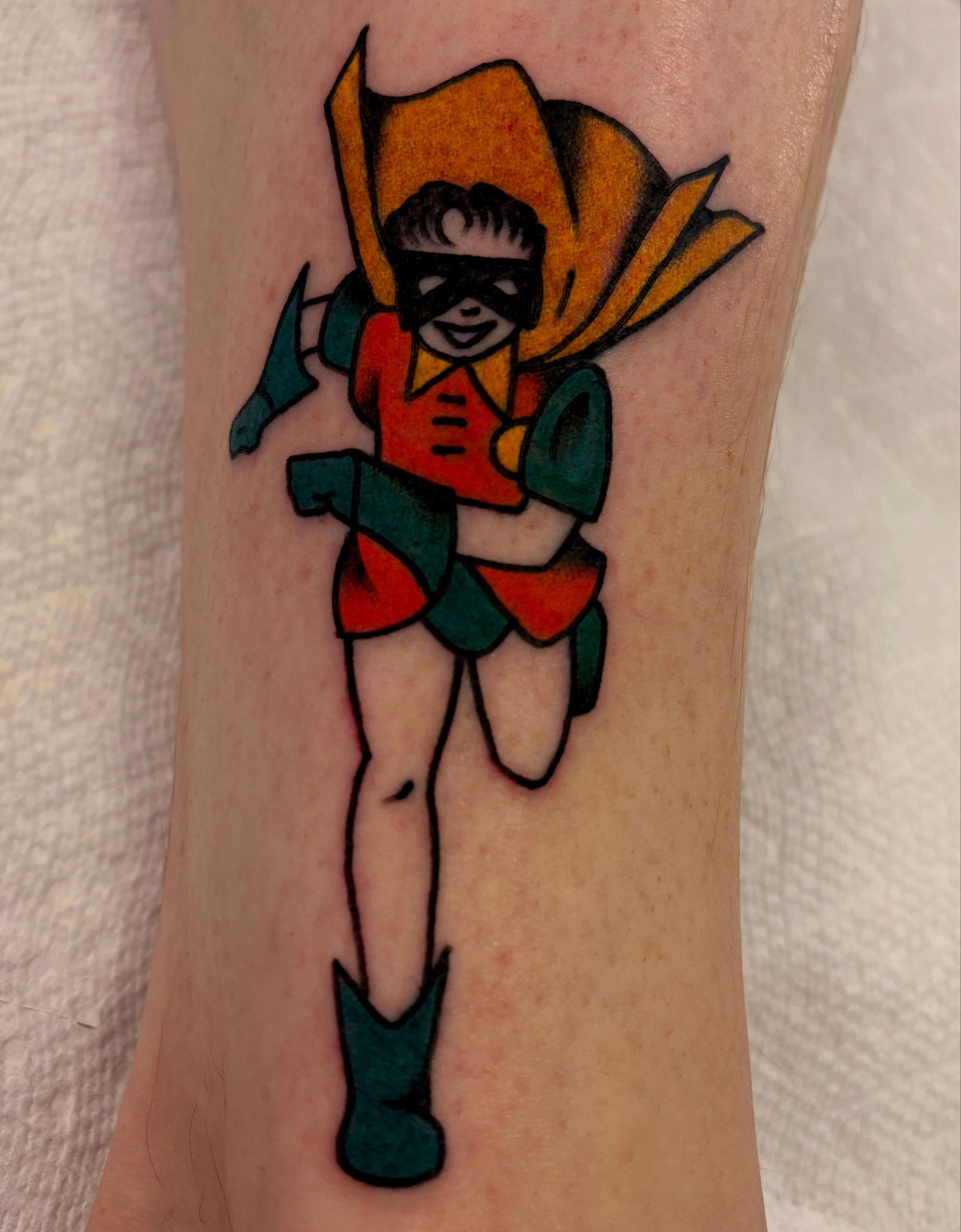Superhero character American traditional tattoo on the forearm by Shane Coslett