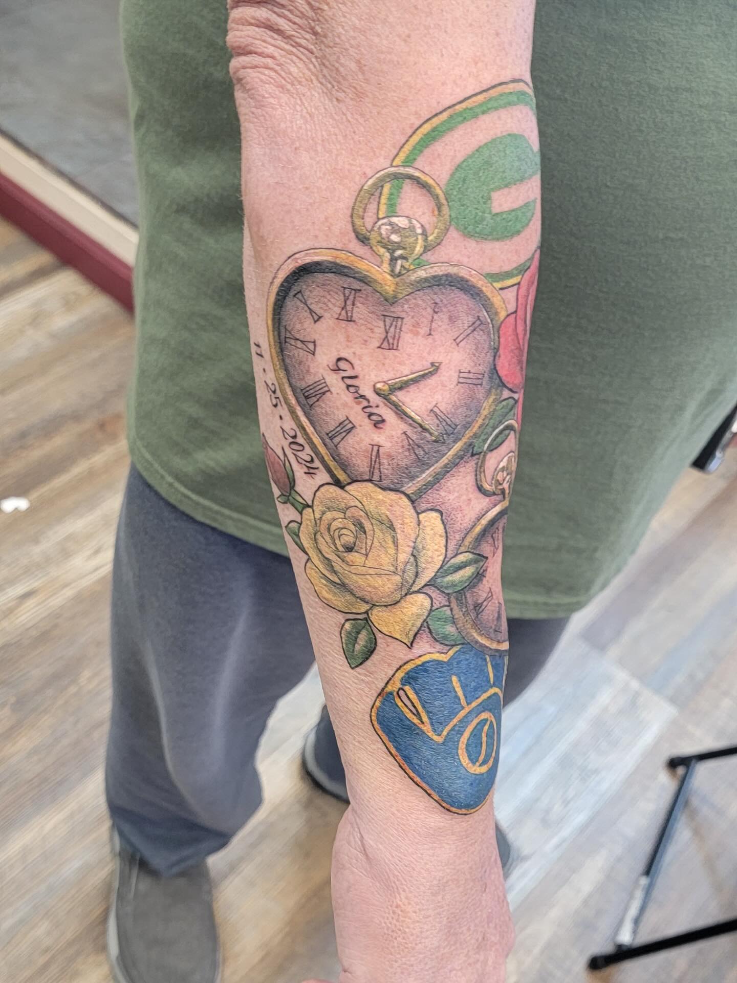 Pocket watch with roses and date tattoo on the forearm by Hatchetfoot Art