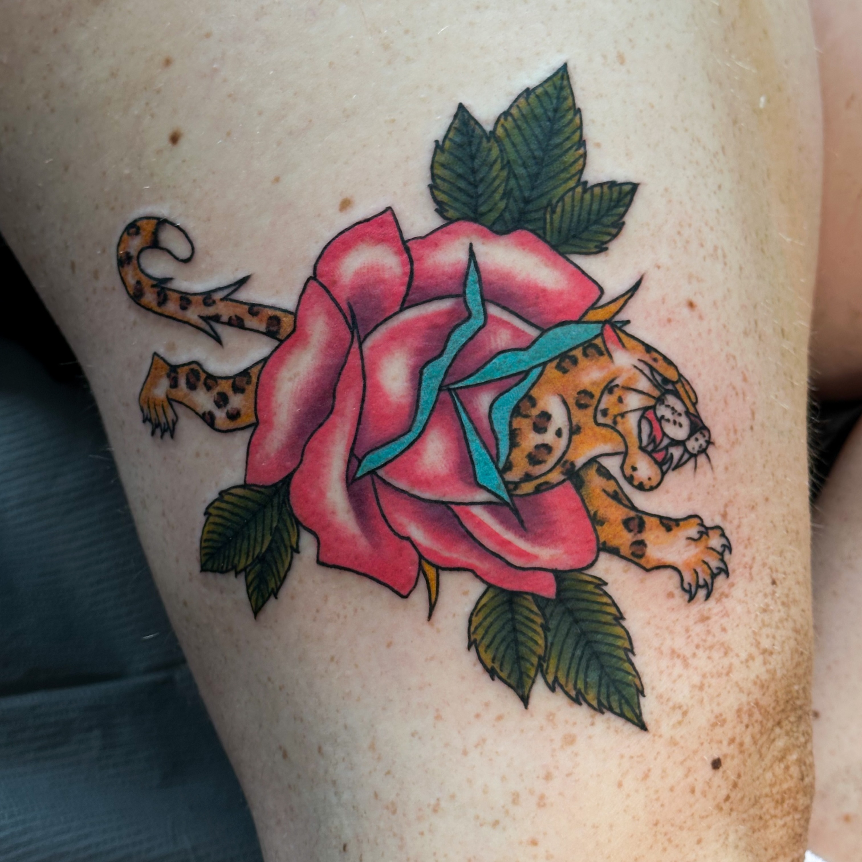 Rose and leopard American traditional tattoo on the thigh by Victoria