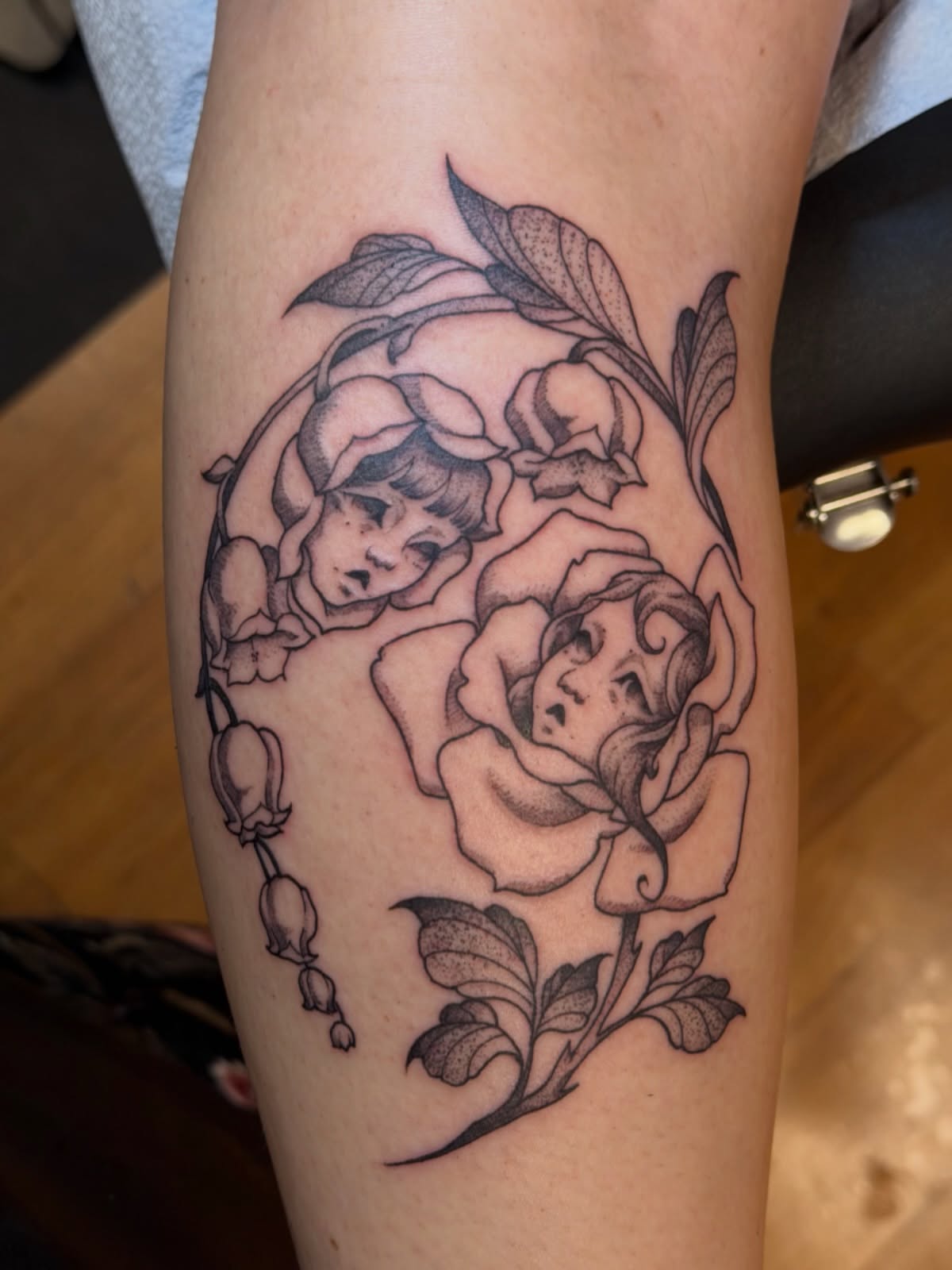 Rose and cherub black and grey tattoo on the forearm by Gianna Calisi