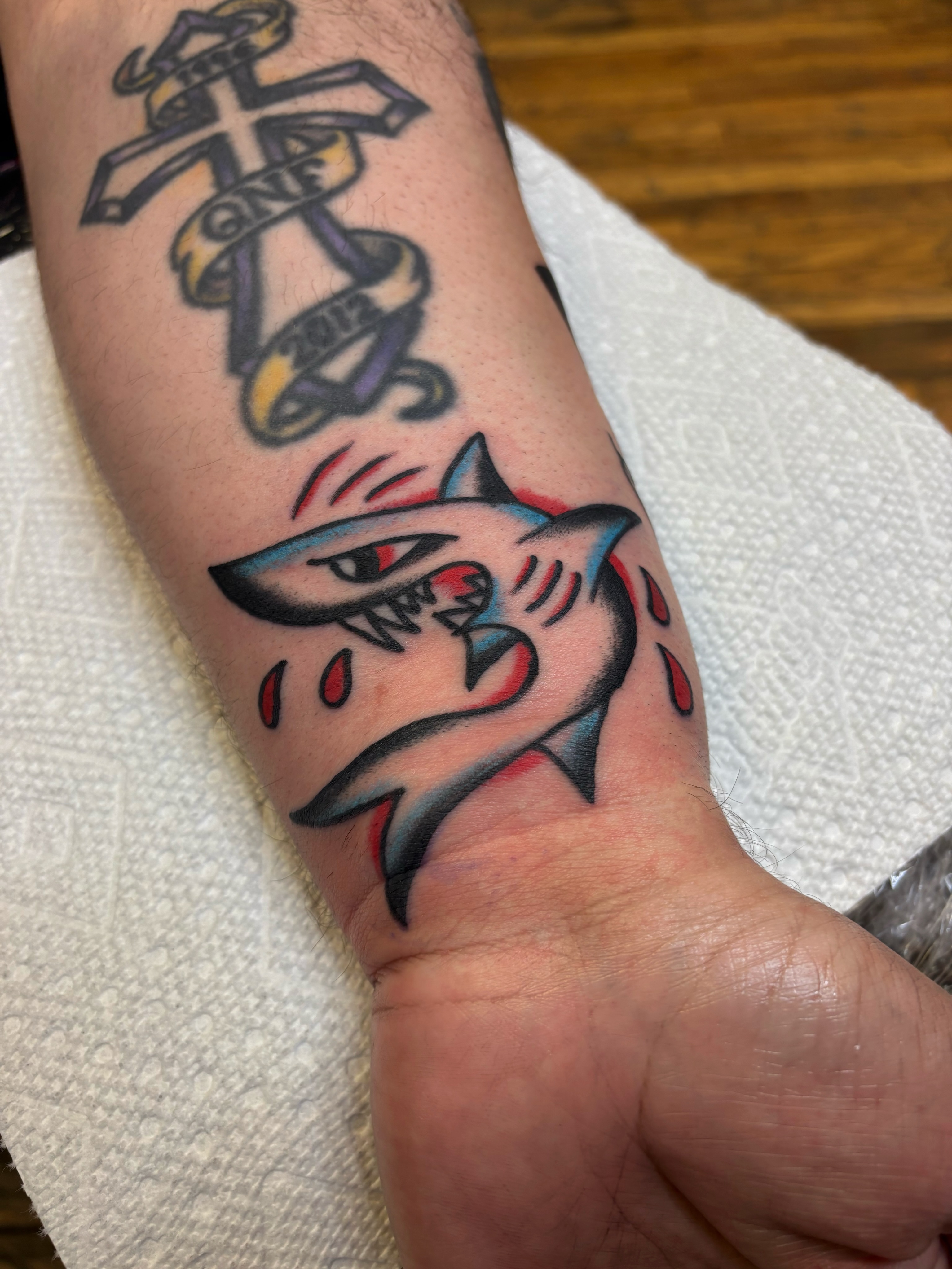 Shark American traditional tattoo on the forearm by Cooper Reichwein