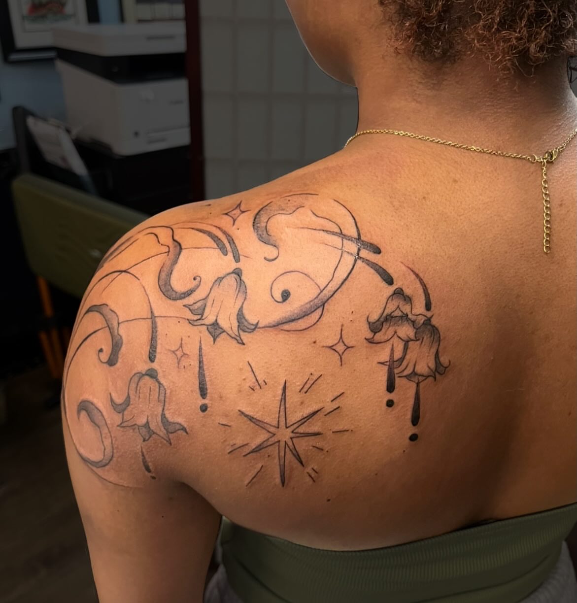 Astronaut and flowers black and grey tattoo on the shoulder by Brianna Jo Ballinghoff
