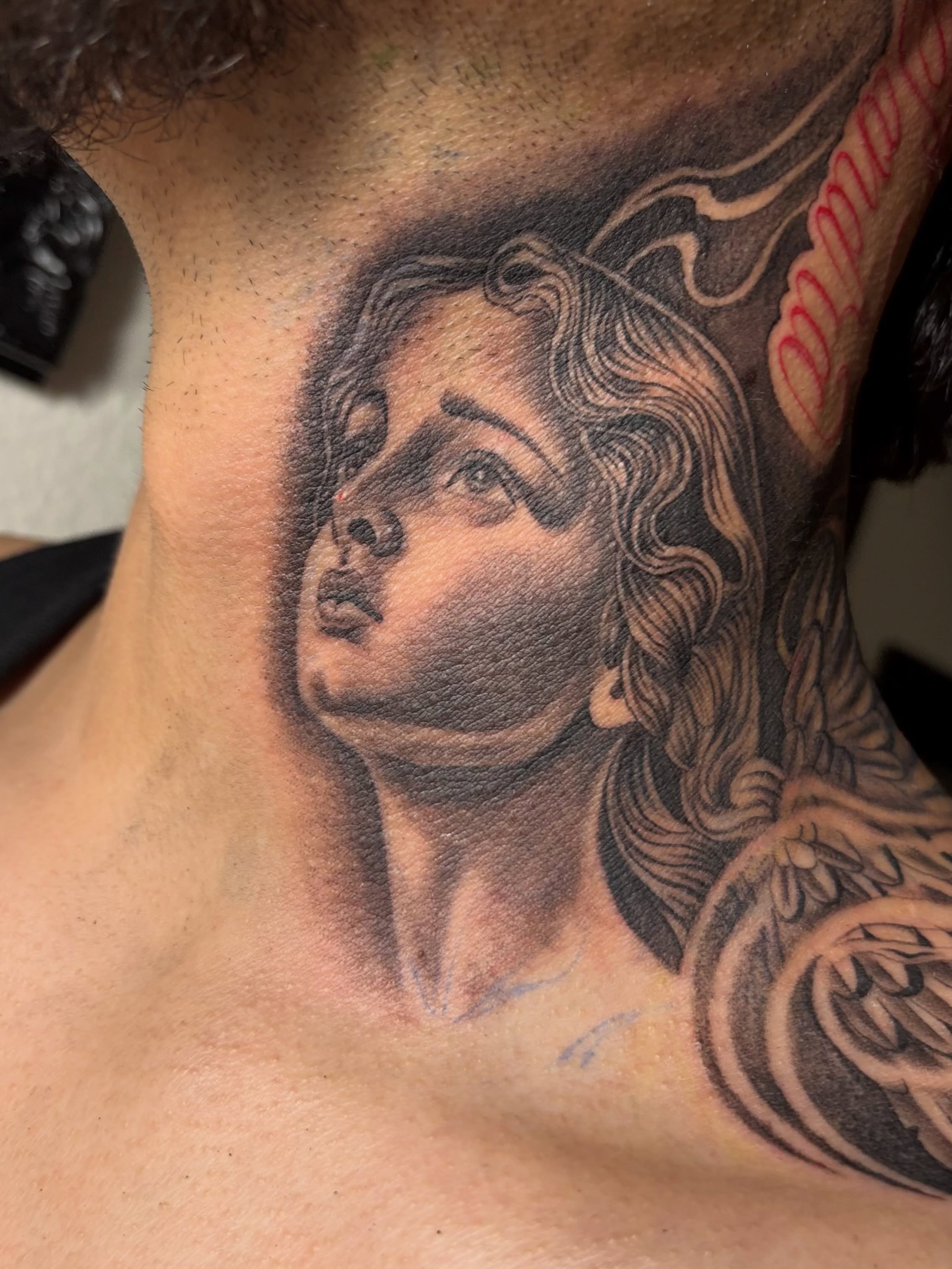 Woman's head realism tattoo on the neck by @tattoosbyadrian