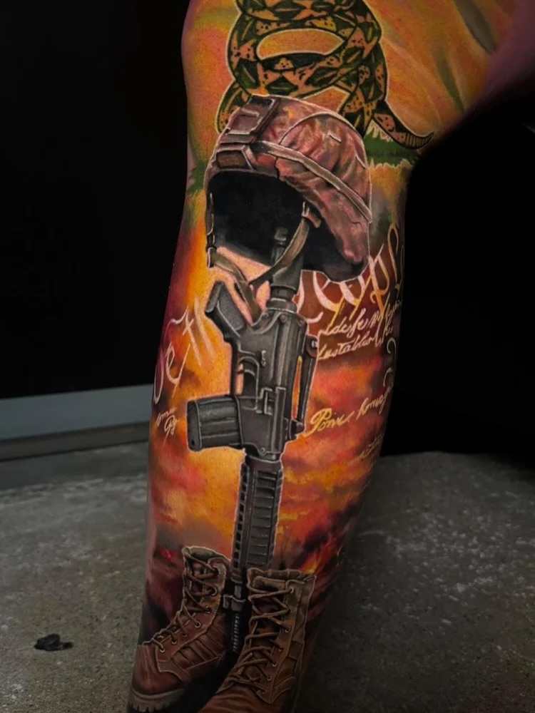 Military helmet and rifle realism tattoo on the leg by Justin Shelpman