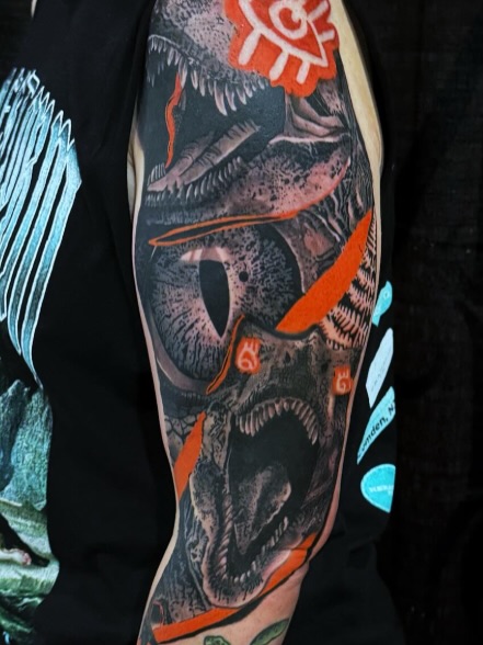 Dinosaur realism tattoo on the forearm by Brandiane Wells