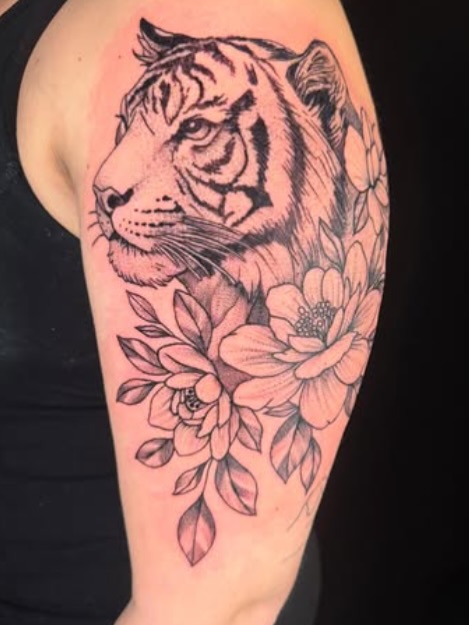 Tiger and flowers realism tattoo on the forearm by Brandiane Wells