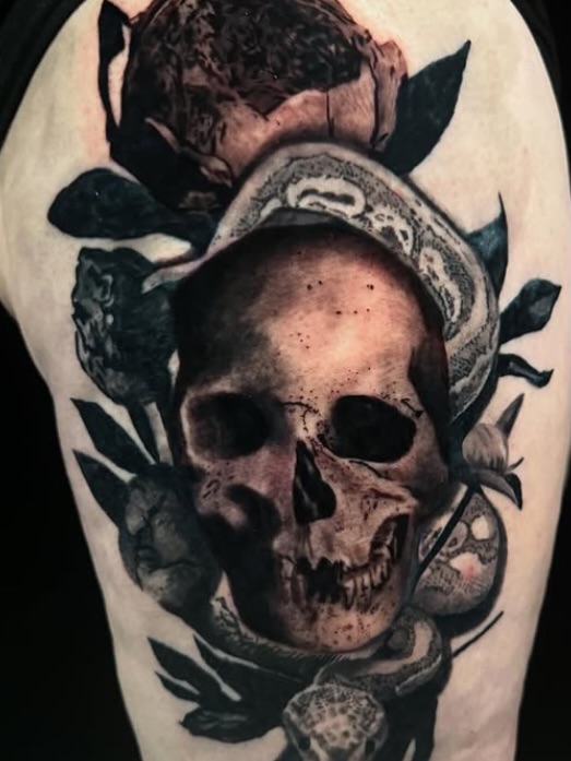Skull and snake realism tattoo on the forearm by Brandiane Wells
