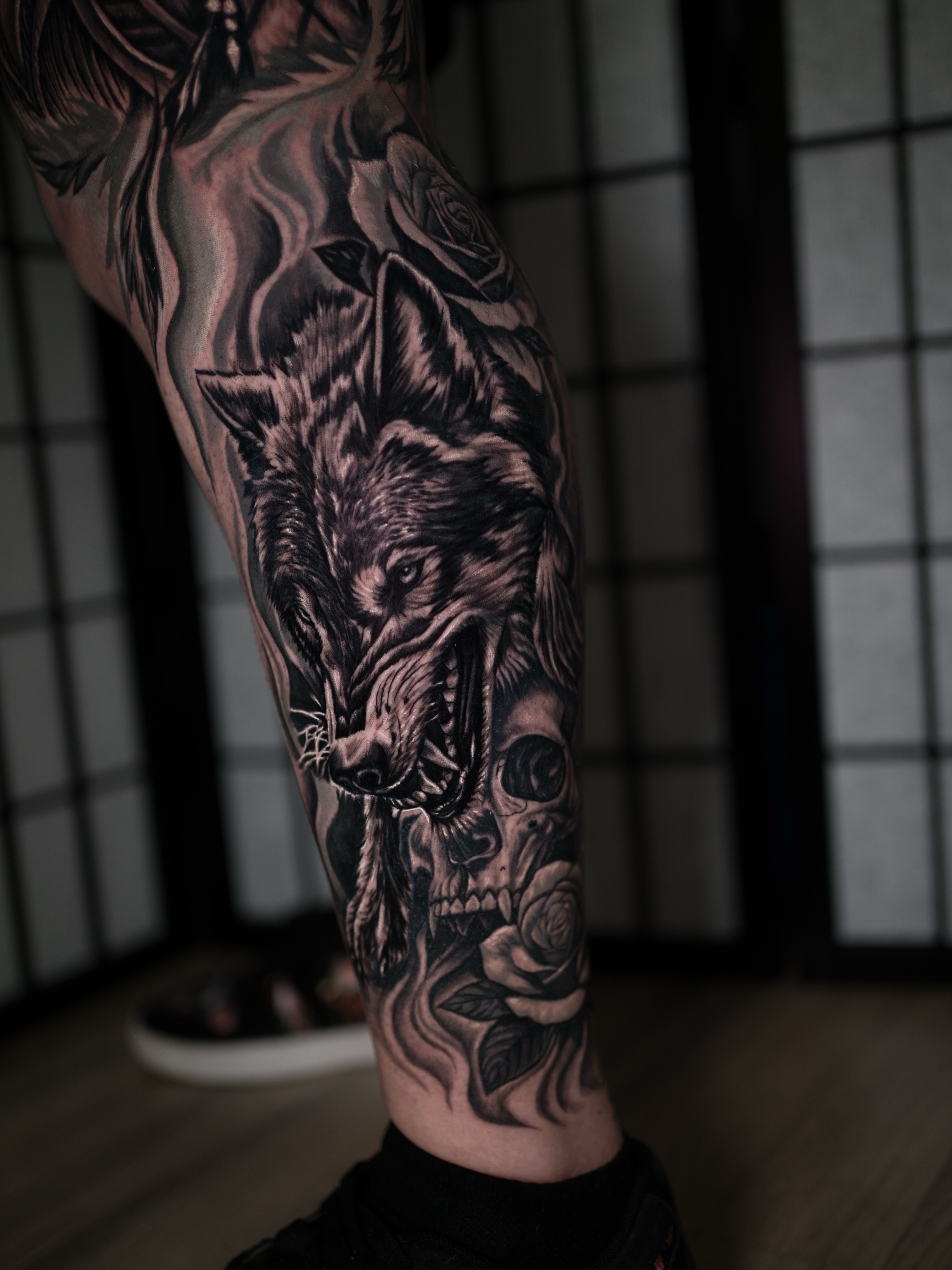 Wolf and skull realism tattoo on the forearm by Juan David Arias