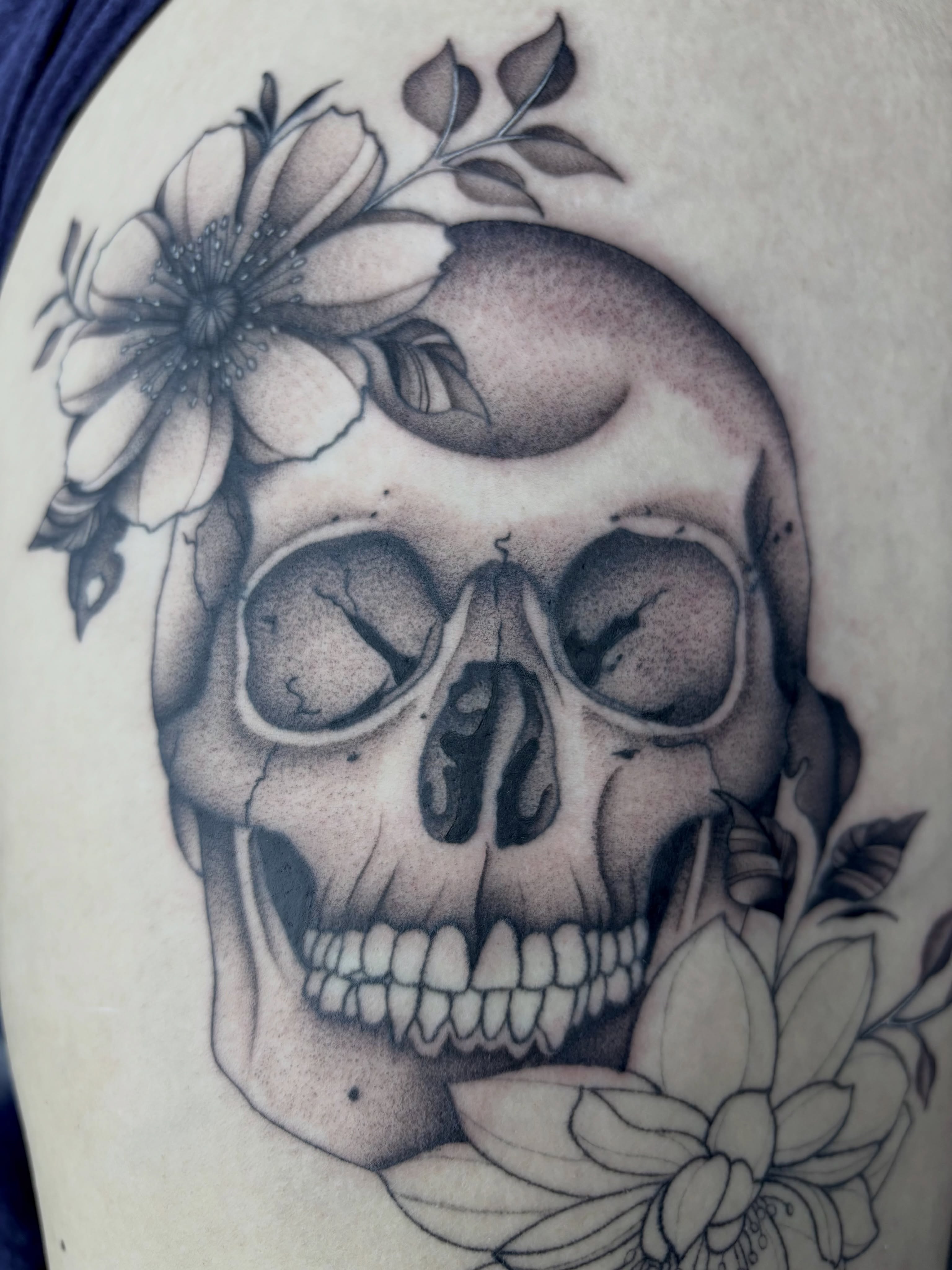 Skull with flowers realism tattoo on the shoulder by Elise Lamoureux- Tattoo Artist, Airdrie, Alberta