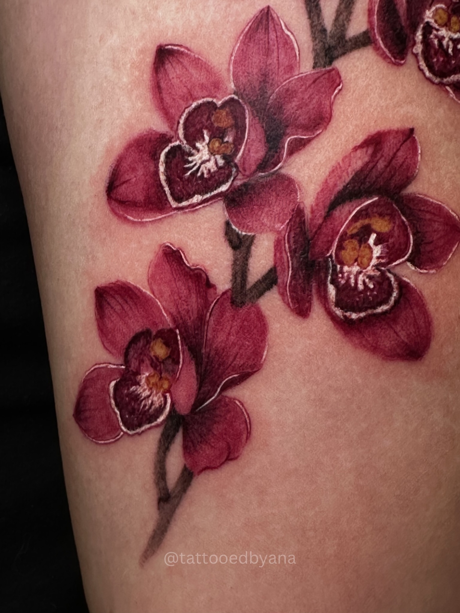 Orchids realism tattoo on the thigh by Tattoo artist Denver