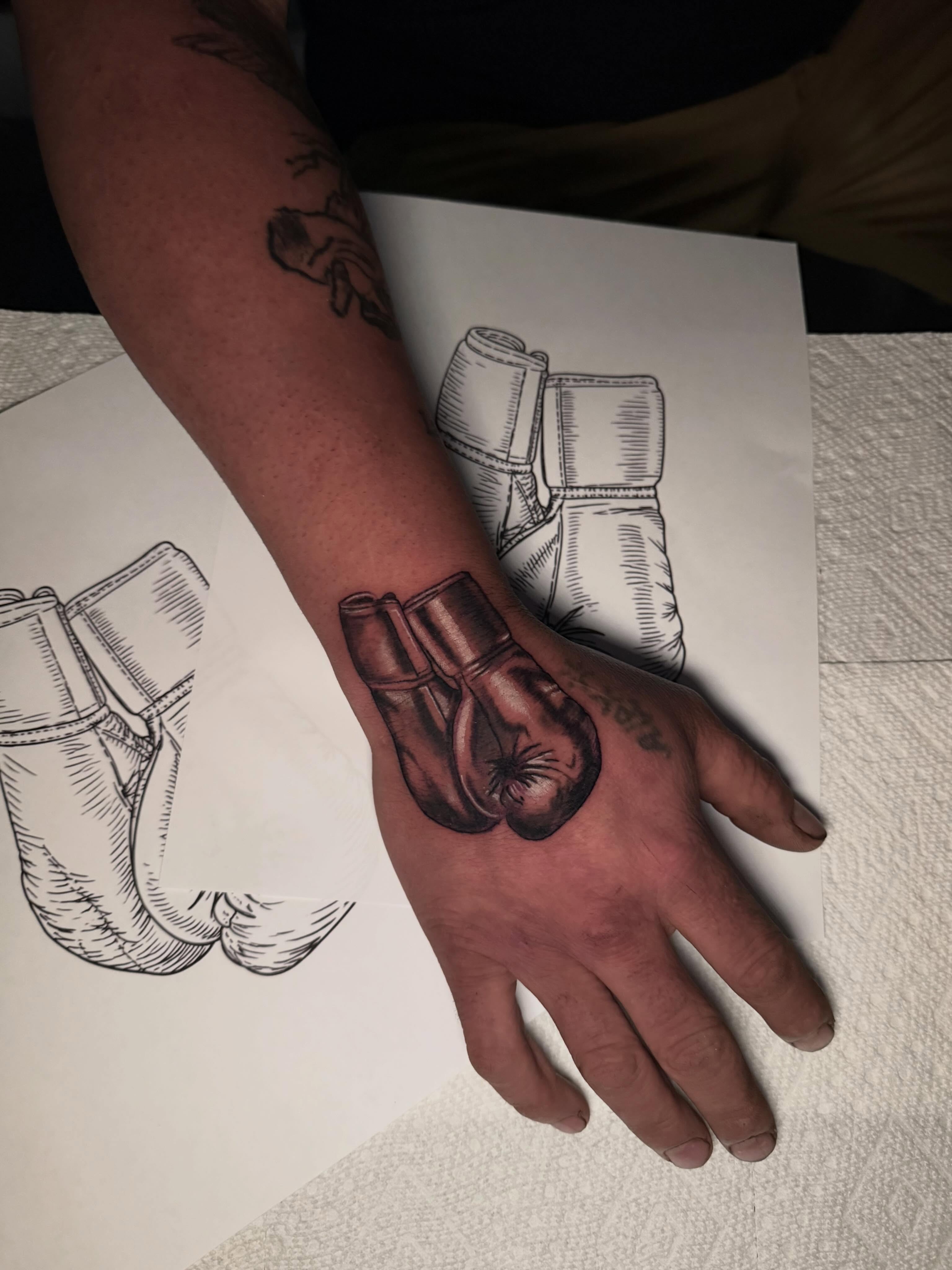 Boxing gloves black and grey tattoo on the hand by 𝕸 𝖆 𝖓 𝖔 𝖑 𝖔