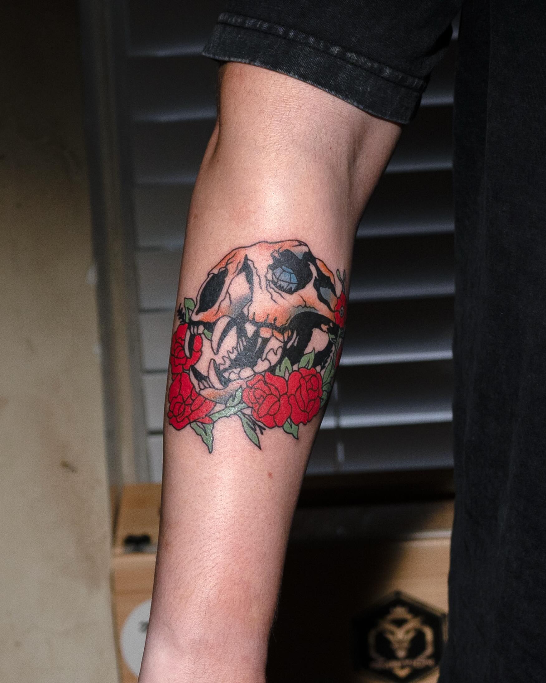 Skull and roses American traditional tattoo on the forearm by Danny Pando