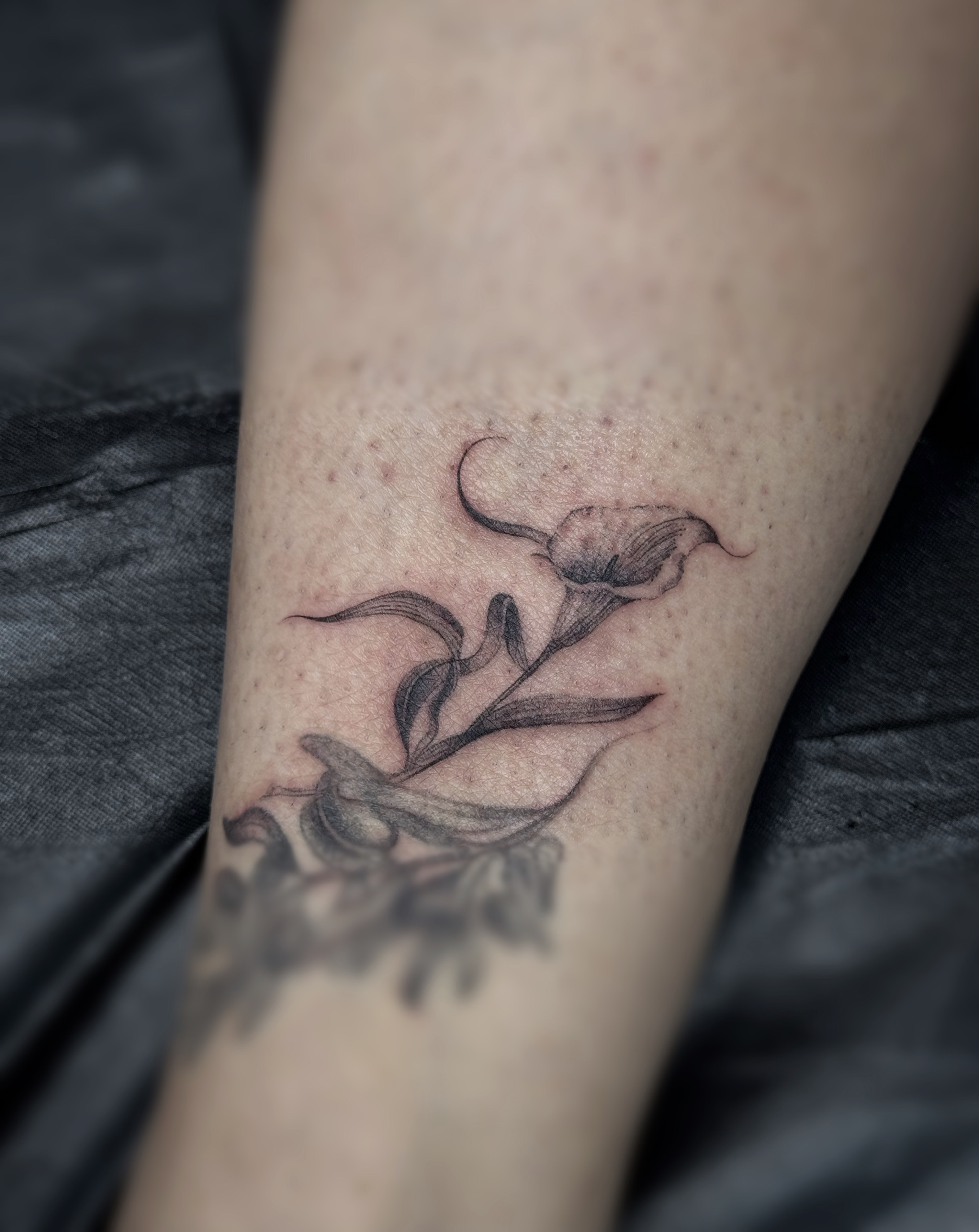 Flower black and grey tattoo on the forearm by Ava De La Torre