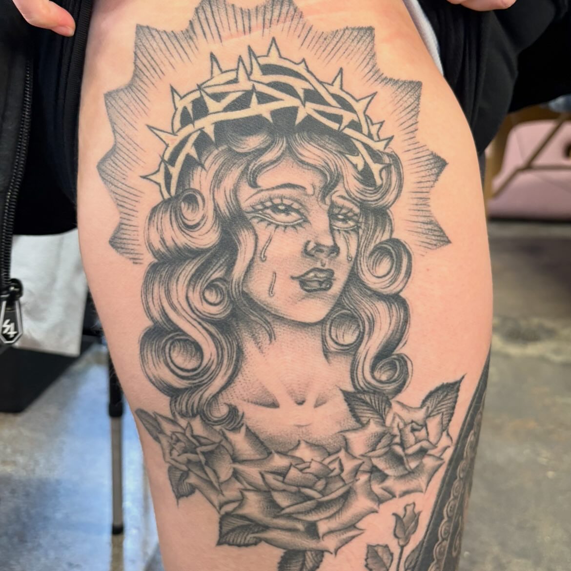 Woman with crown of thorns realism tattoo on the thigh by Sanjuanita
