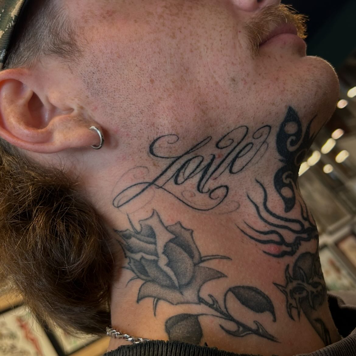 Love lettering script tattoo on the neck by Sanjuanita