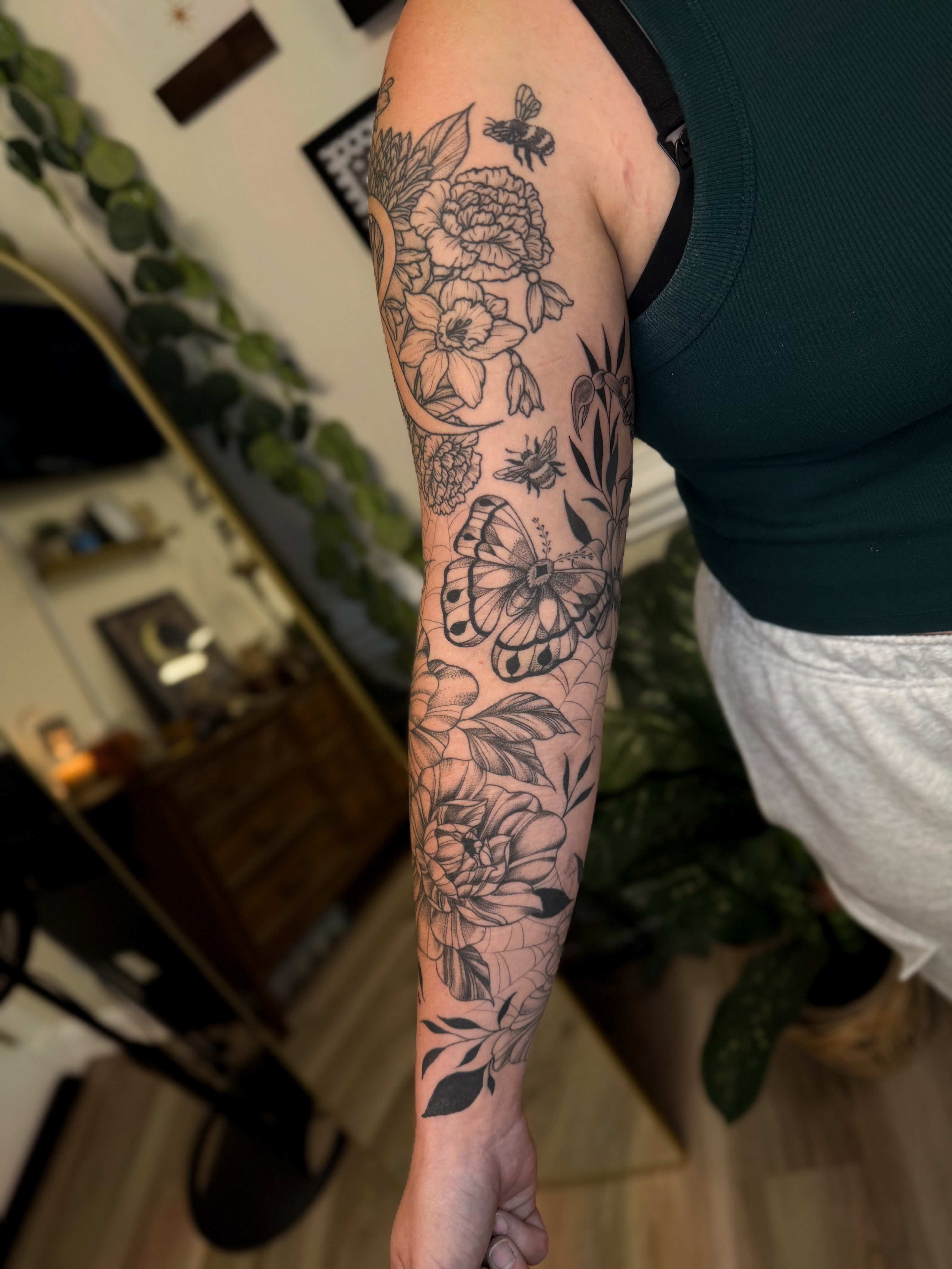Floral bouquet black and grey tattoo on the forearm by McKenna