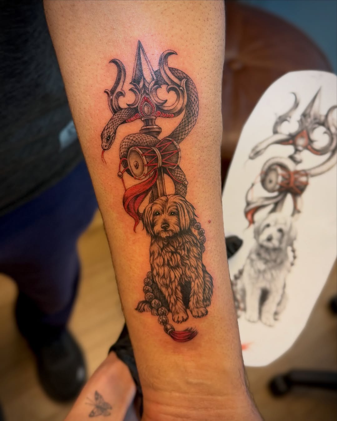 Dog and trident neo-traditional tattoo on the forearm by Aristova Anastasia