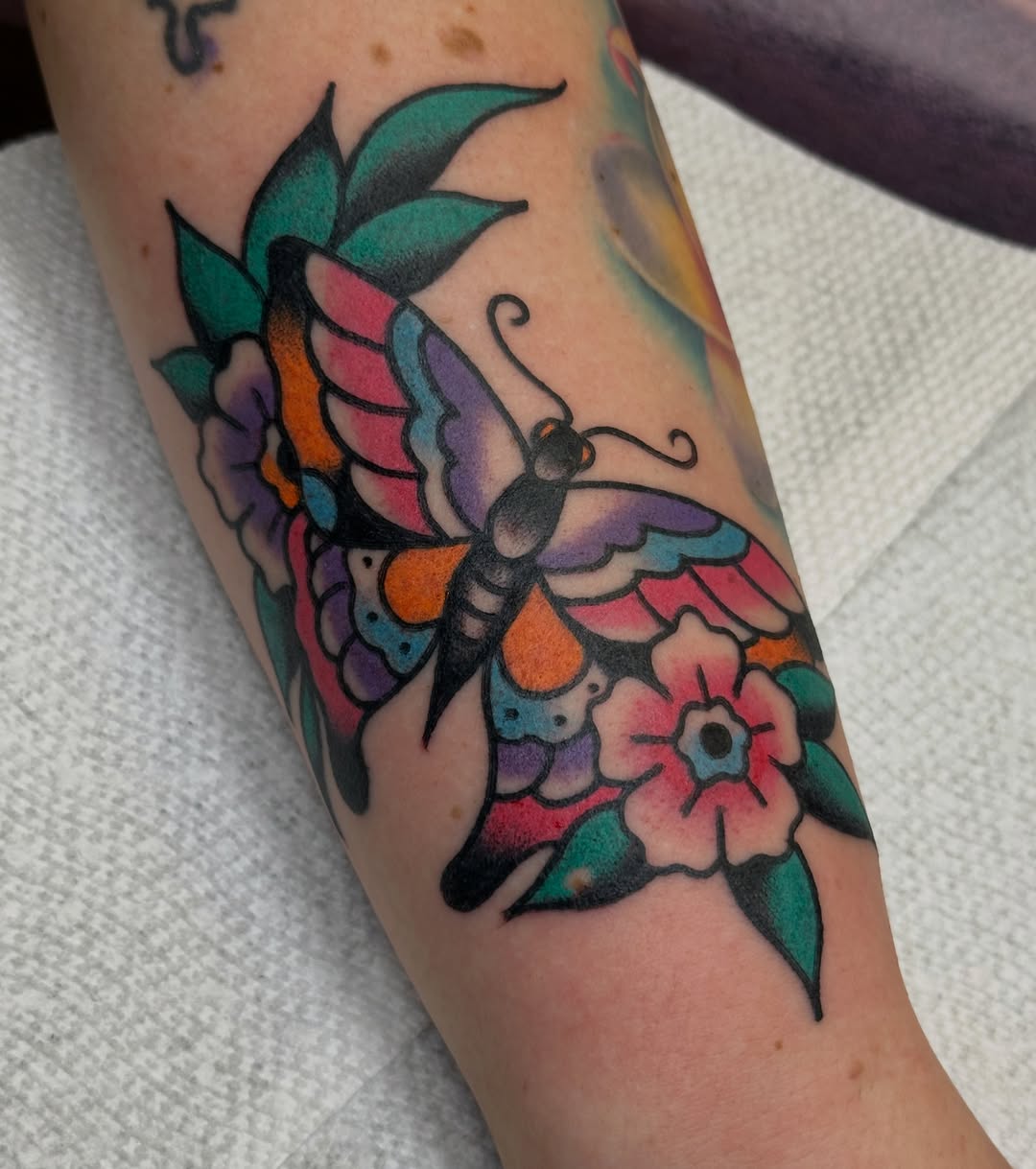 Butterfly and flowers American traditional tattoo on the forearm by Amanda Bonhomme, Las Vegas, Nevada