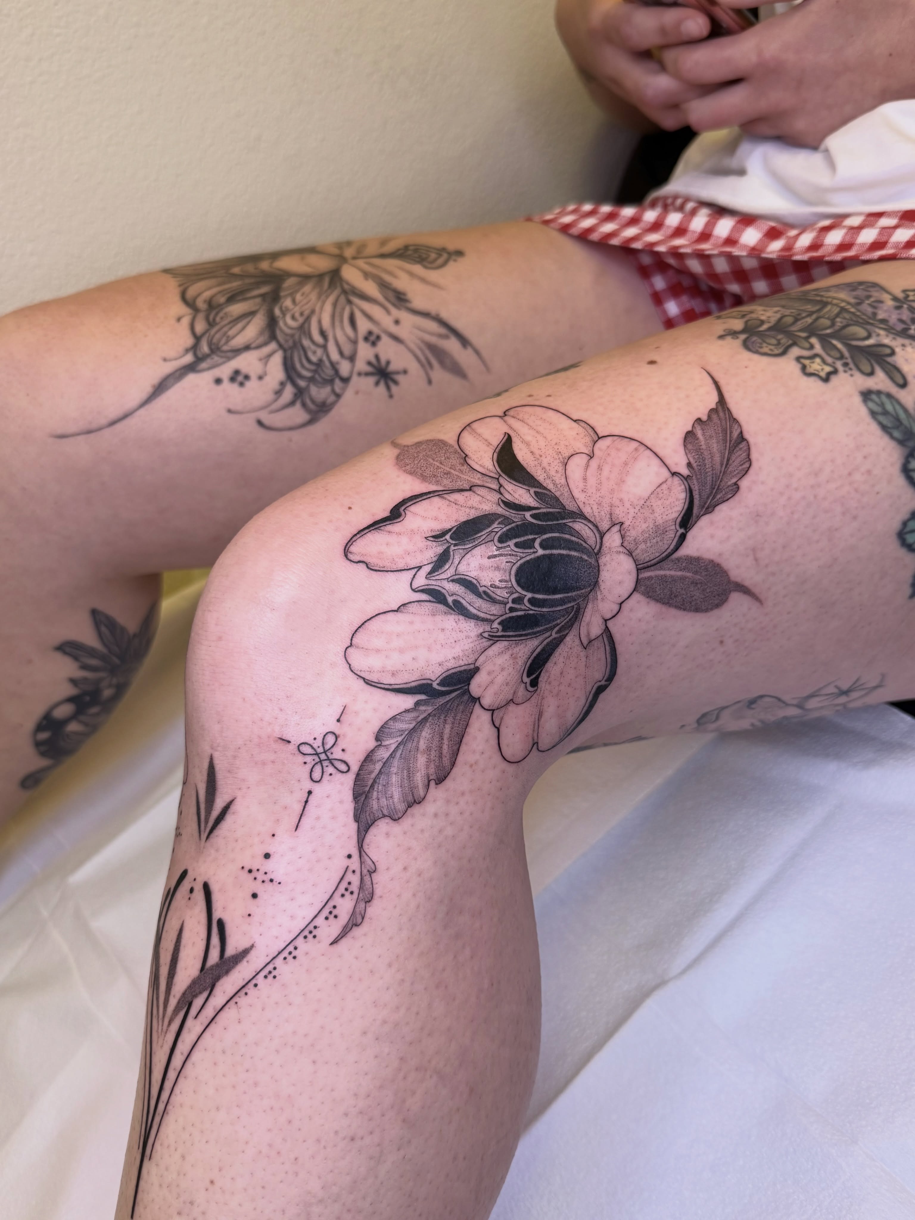 Flower dotwork tattoo on the thigh by Jena Perry