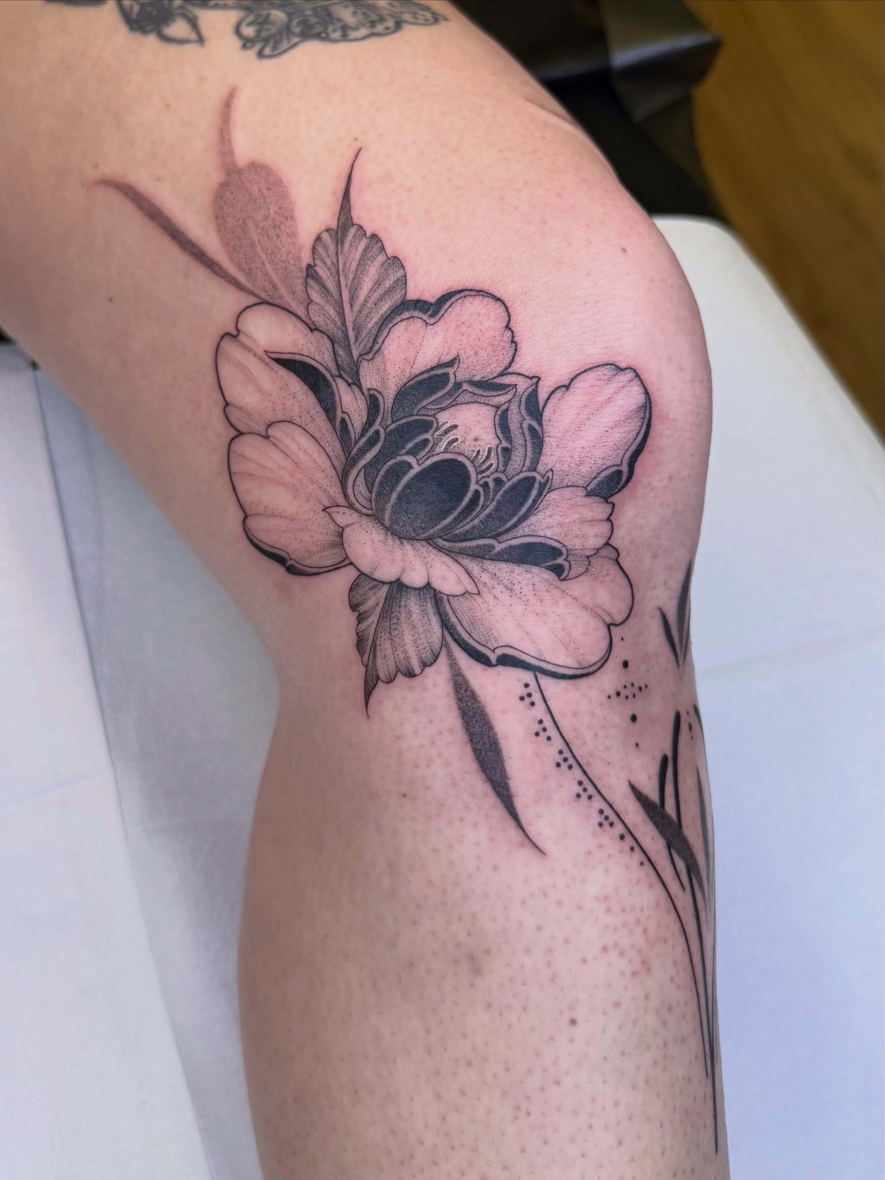 Peony black and grey tattoo on the forearm by Jena Perry