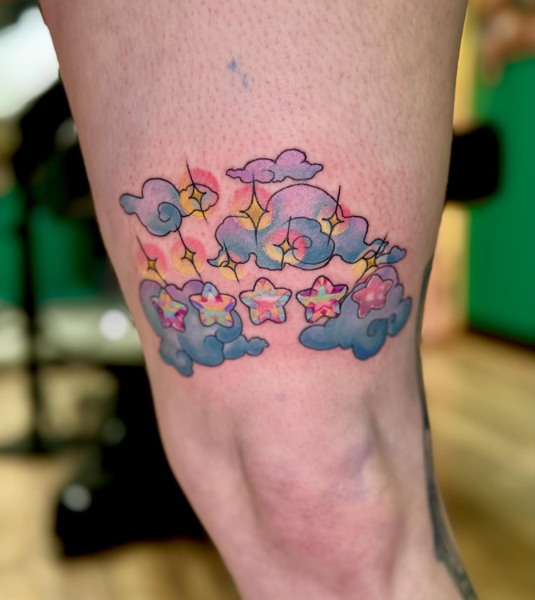 Clouds and stars new school tattoo on the leg by Eileen Joyce