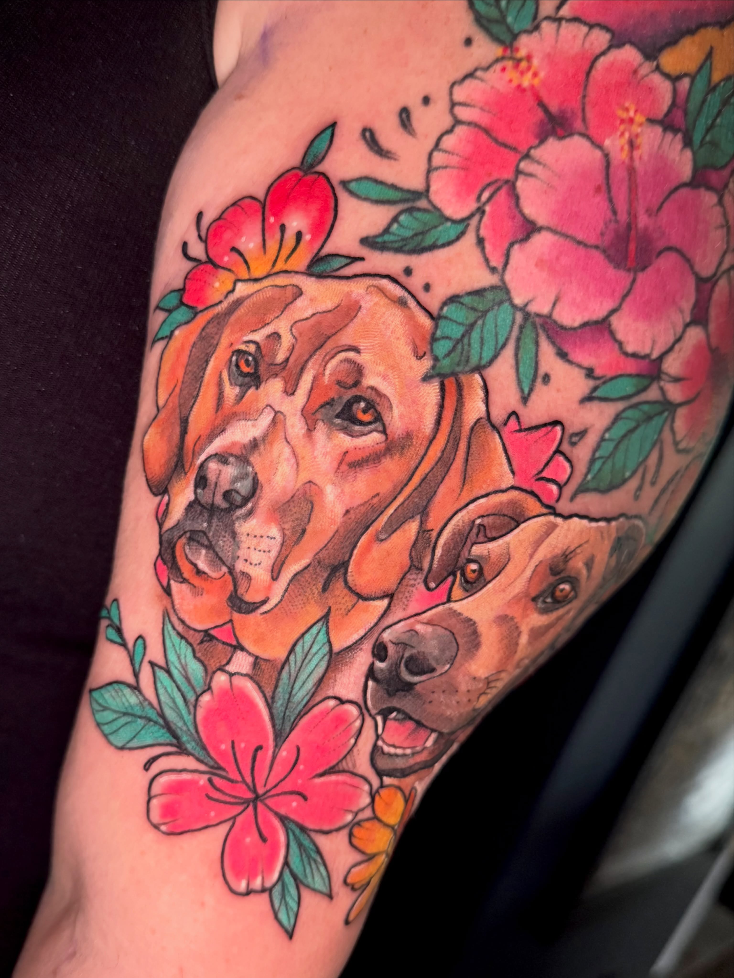 Dogs and flowers realism tattoo on the forearm by Paul Endres Jr