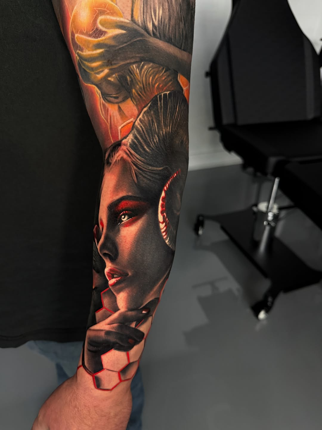 Woman with horns and orb realism tattoo on the forearm by Dakota Case