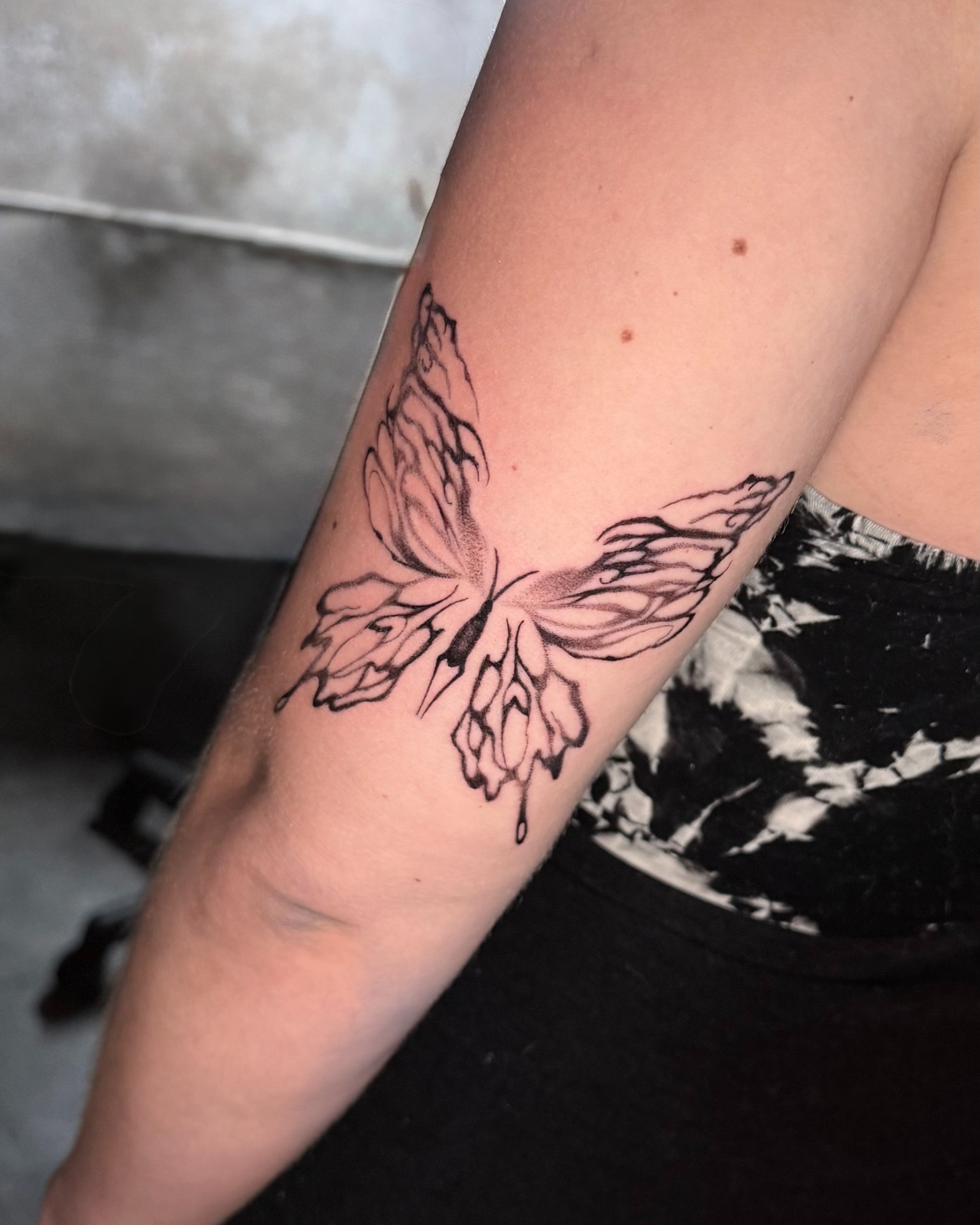 Butterfly black and grey tattoo on the forearm by Tattoo Artist Vanessa