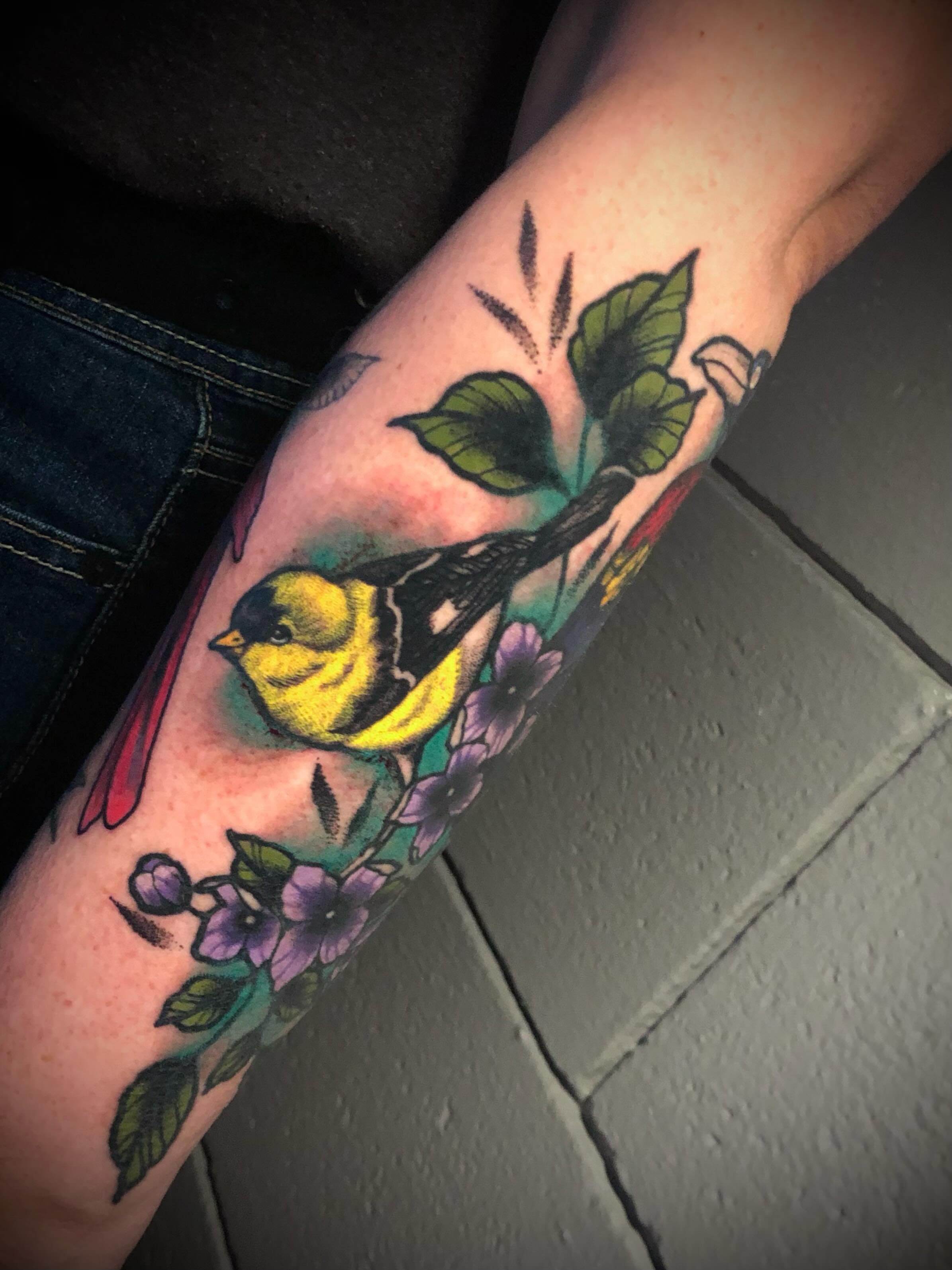 Bird and flowers American traditional tattoo on the forearm by Adrian Michigan Tattoo Artist