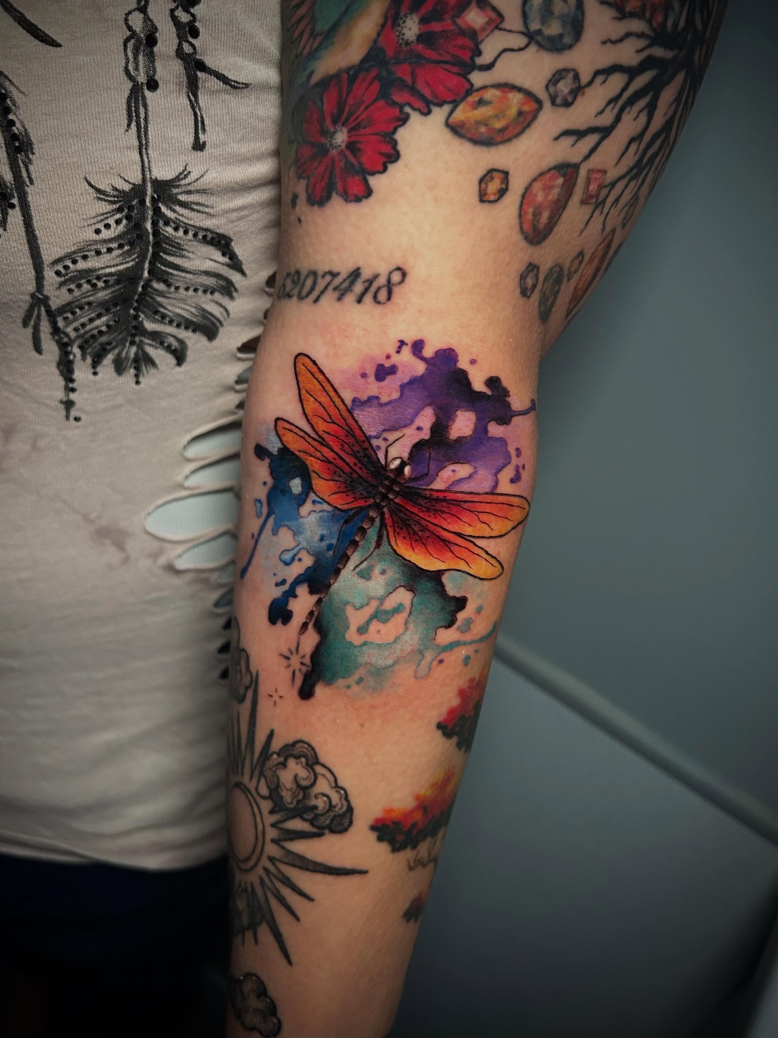 Dragonfly watercolor tattoo on the forearm by Adrian Michigan Tattoo Artist