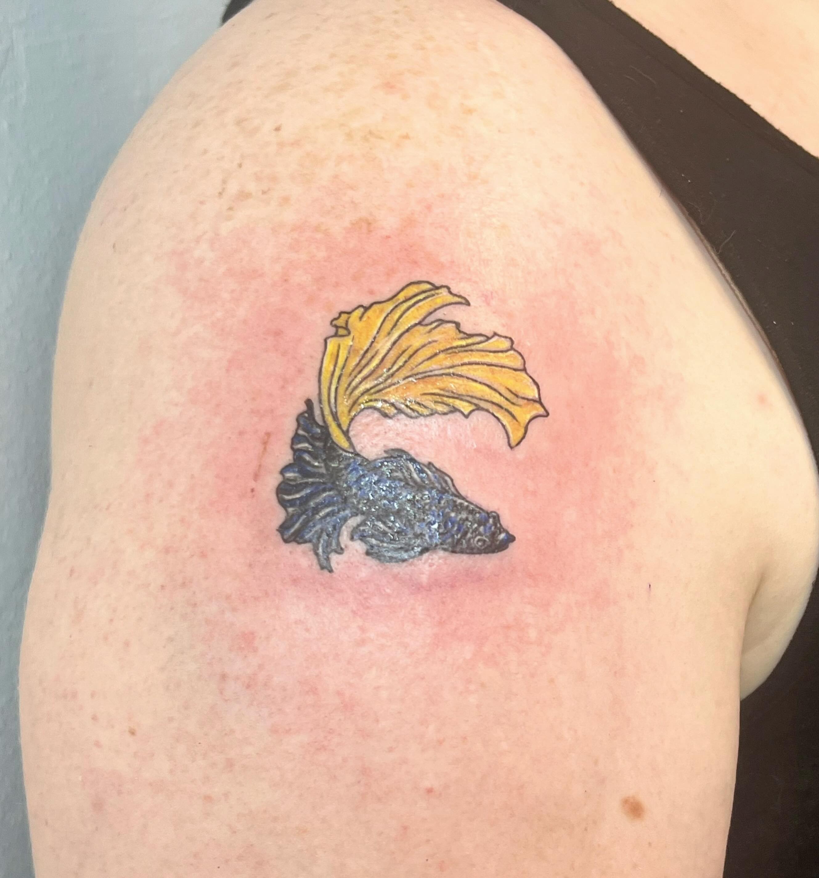 Fish dotwork tattoo on the shoulder by Amber Rose