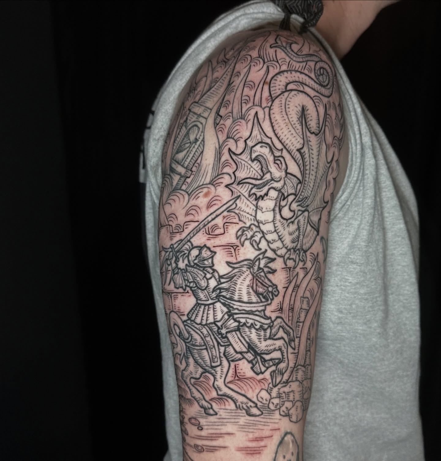 Horseman and dragon realism tattoo on the upper arm by Joel Smith, Manhattan, Kansas